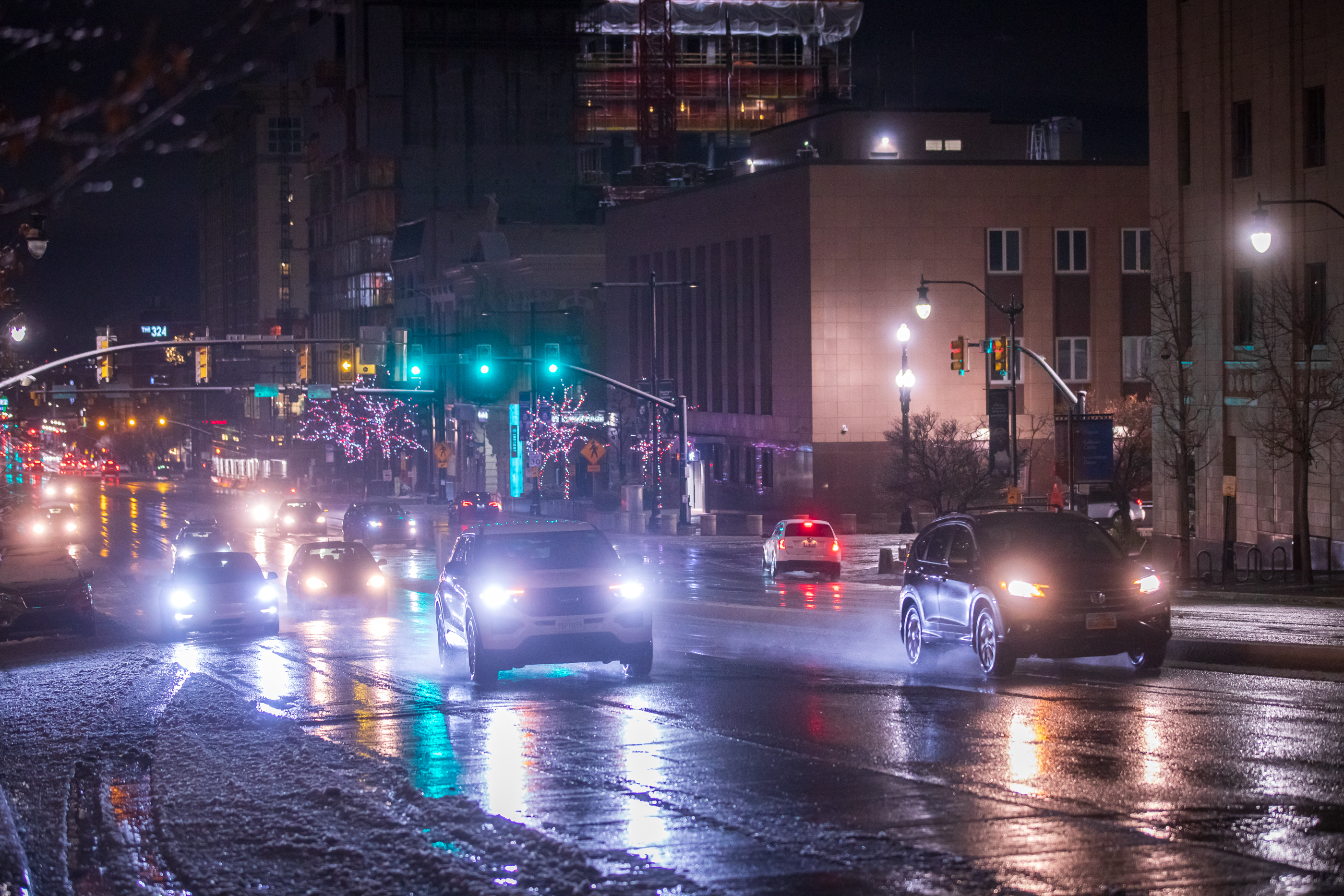 Cars travel through water and slush on State Street in Salt Lake City Tuesday night. A mixture of rain and snow returned to northern Utah's valleys Tuesday night and is expected to linger into Wednesday morning.