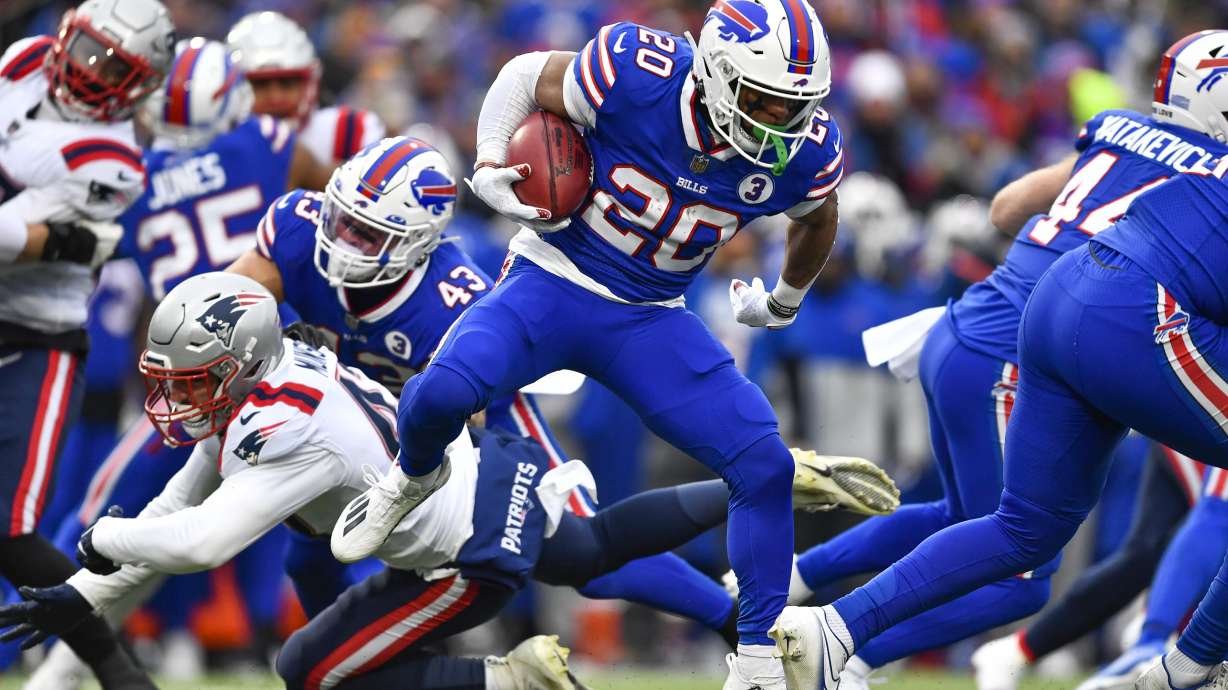 Buffalo Bills running back Nyheim Hines (20) runs in a touchdown on a kickoff return during the first half of an NFL football game against the New England Patriots, Sunday, Jan. 8, 2023, in Orchard Park.
