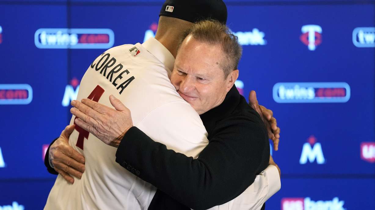 Minnesota Twins' Carlos Correa, left, and agent Scott Boras hug following a baseball press conference at Target Field, Wednesday, Jan. 11, 2023, in Minneapolis. The team and Correa agreed to a six-year, $200 million contract.