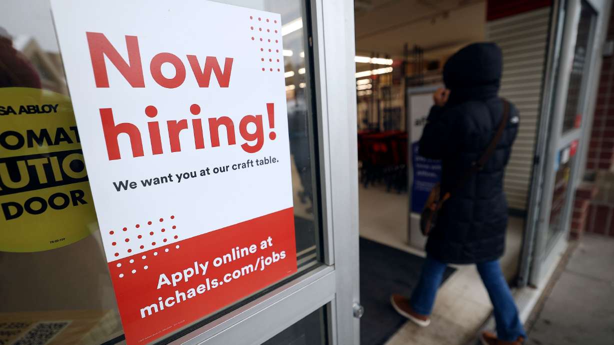 A “Now hiring!” sign is pictured on the door to Michaels in Salt Lake City on Jan. 6. Unsettled and unprecedented conditions have turned economic forecasting into a game of three-card monte since the worst of COVID-19 restrictions have subsided.