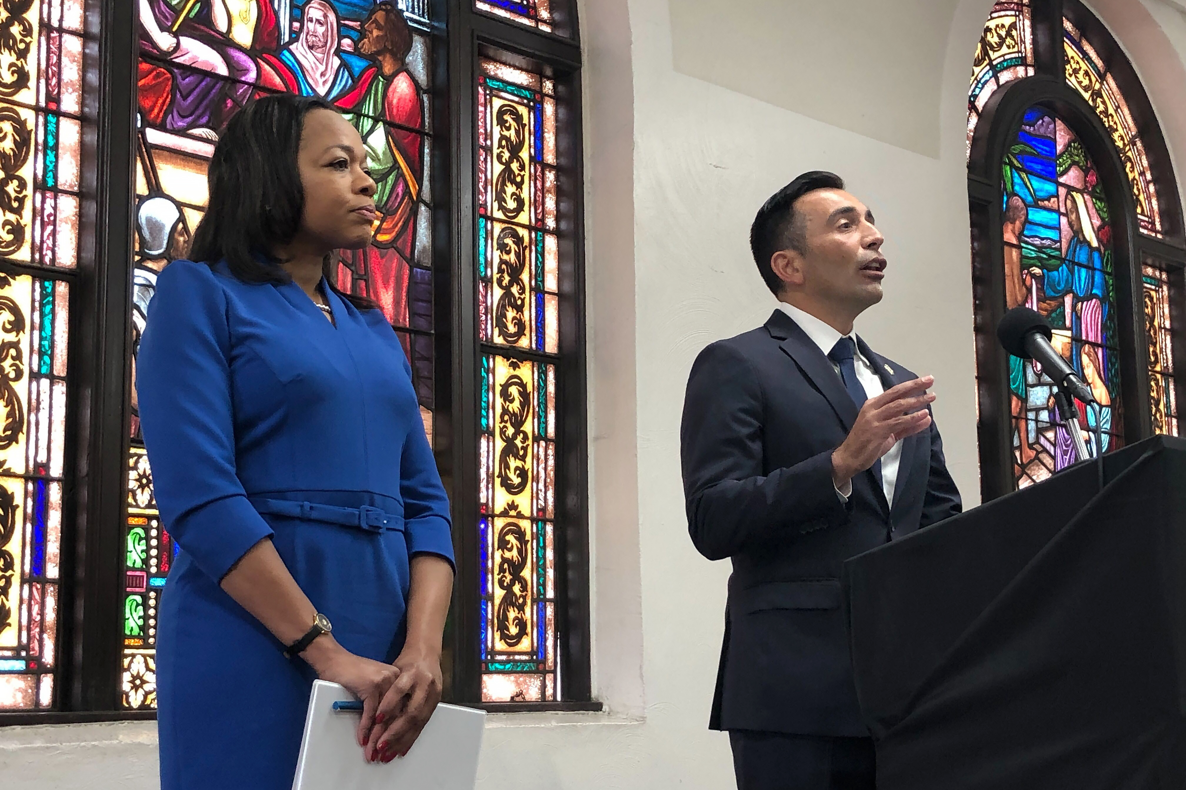 Assistant Attorney General of the U.S. Department of Justice's Civil Rights Division Kristen Clarke, left, listens as United States Attorney Martin Estrada speaks while announcing the largest redlining case in American history Thursday at the Second Baptist Church in Los Angeles.