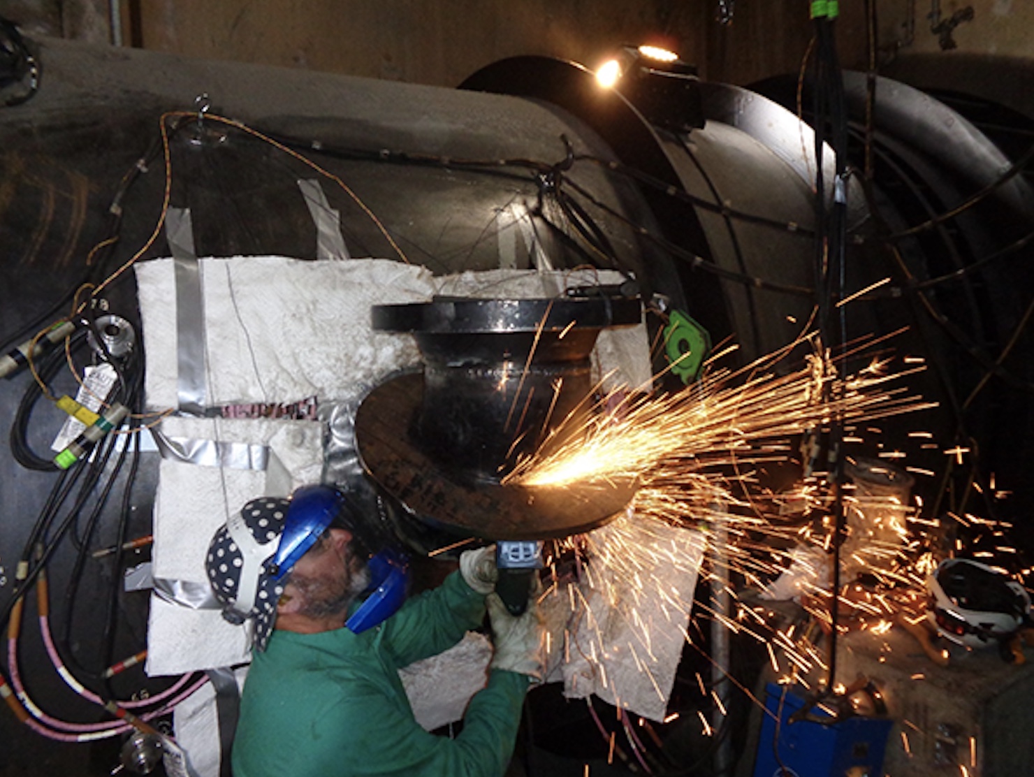 Joseph Sams, a mechanic apprentice, grinds a coupling that is part of the new lower water intake for the city of Page, Arizona. Reclamation crews at Glen Canyon Dam constructed the new intake as a precaution since Lake Powell’s elevation is at historically low levels.