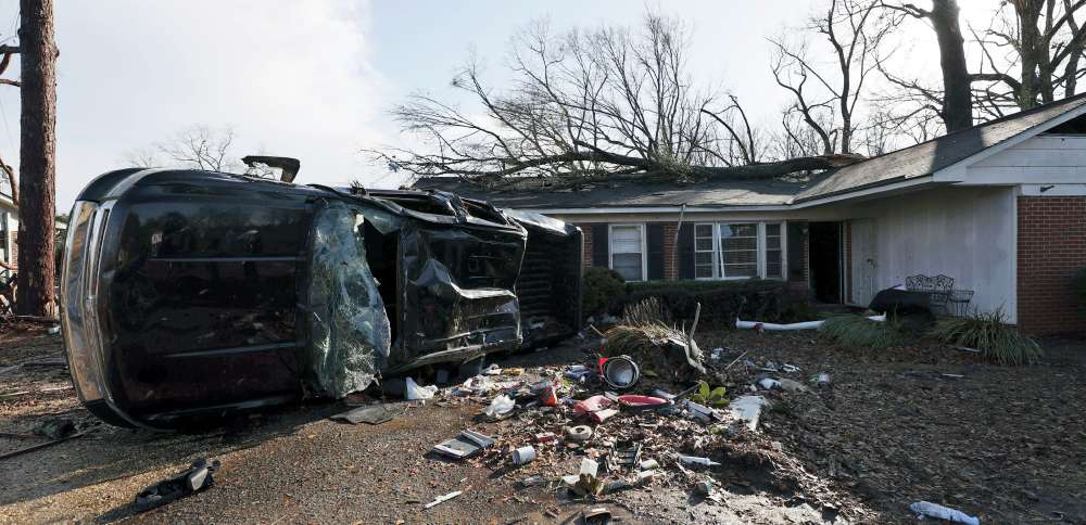 A vehicle is upended and debris is strewn about following a tornado near Meadowview Elementary School on Thursday in Selma, Alabama.
