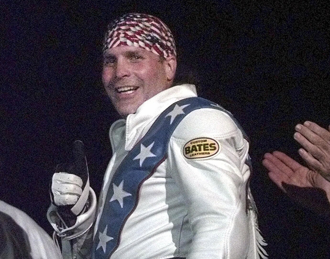 FILE - Robbie Knievel gives a thumbs up after jumping a train at the Texas State Railroad Park in Palestine, Texas on Feb. 23, 2000. 