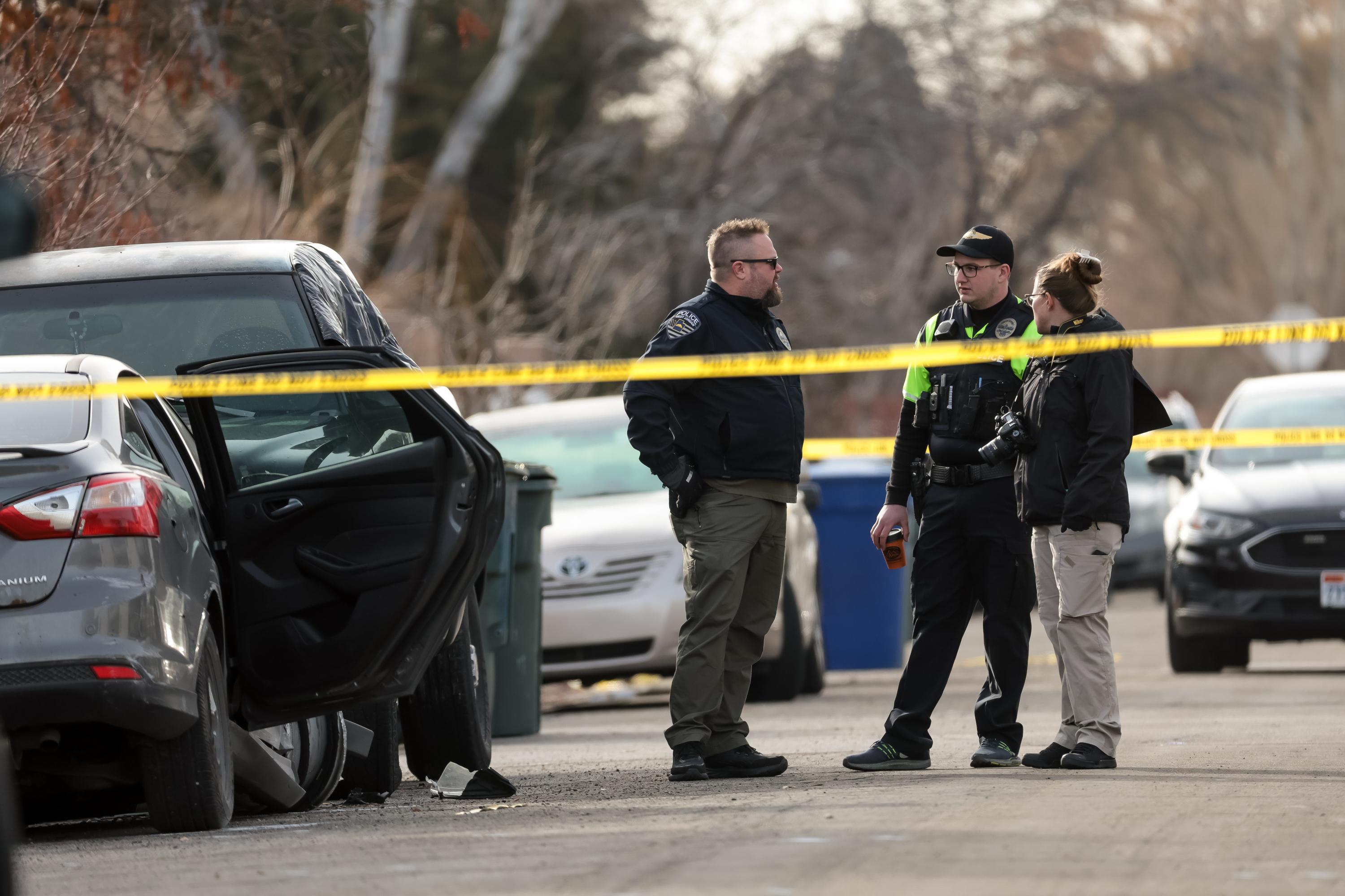Police officers investigate the scene where Salt Lake police shot a person who fled after a pursuit in Salt Lake City on Friday, Jan. 13. Police said Saturday that the individual has since died, but provided few other details.