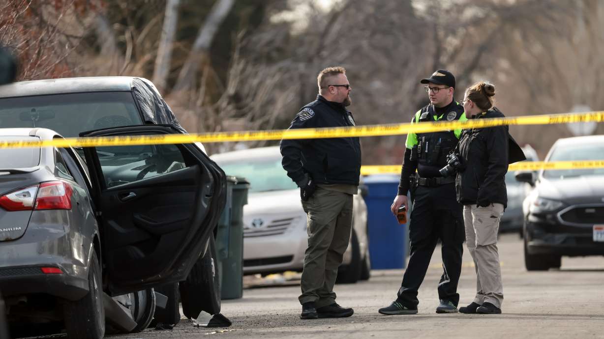 Police officers investigate the scene where Salt Lake police shot a person who fled after a pursuit in Salt Lake City on Friday, Jan. 13. Police said Saturday that the individual has since died, but provided few other details.