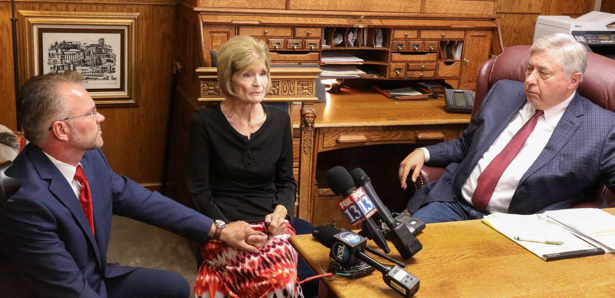 Connie Elison, the mother and heir of Thomas Ray Stanfield, who was shot to death on June 20, 2018, holds the hand of her son, Grant Stanfield, as they talk with members of the media about what happened in the shooting during a press conference in the office of attorney Robert Sykes, right, in Salt Lake City on June 26, 2018.