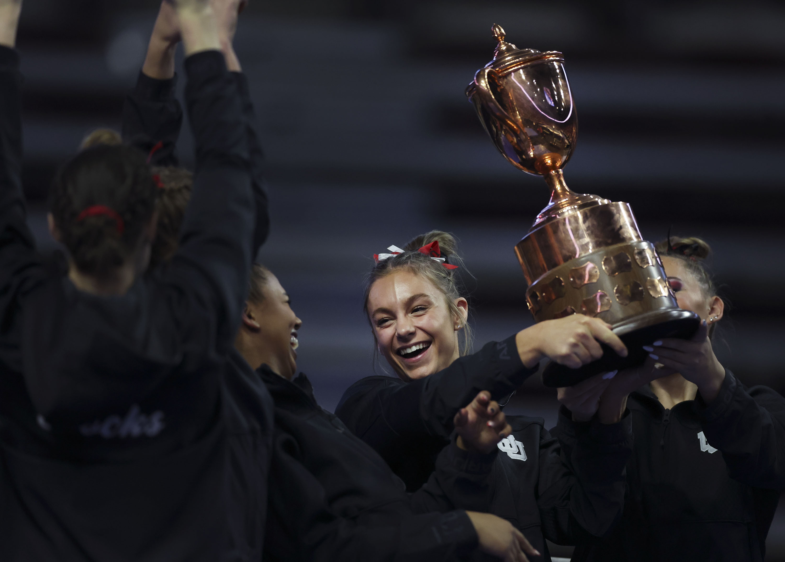 Utah's Grace McCallum hoists the team’s trophy after winning the fourth annual Rio Tinto Best of Utah Meet at the Maverik Center in West Valley City on Friday, Jan. 13, 2023.