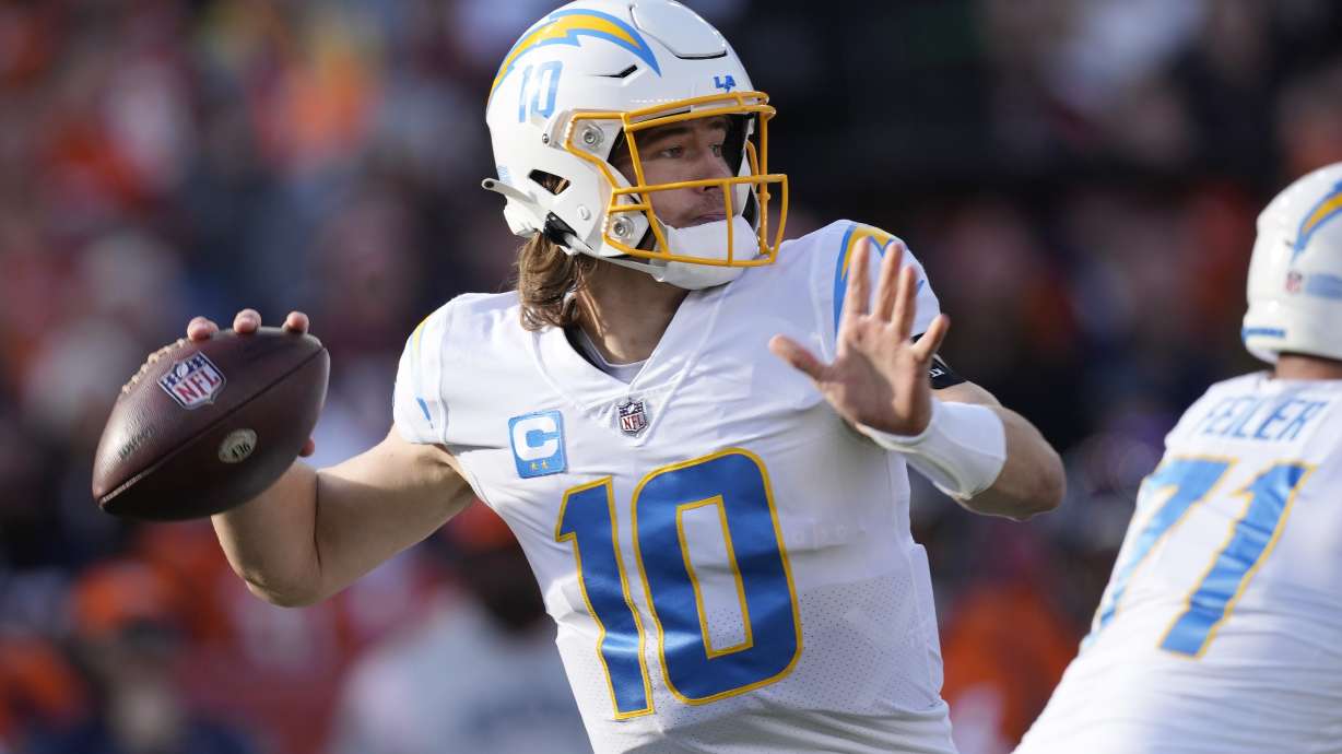Los Angeles Chargers quarterback Justin Herbert (10) throws against the Denver Broncos during the first half of an NFL football game in Denver, Sunday, Jan. 8, 2023.