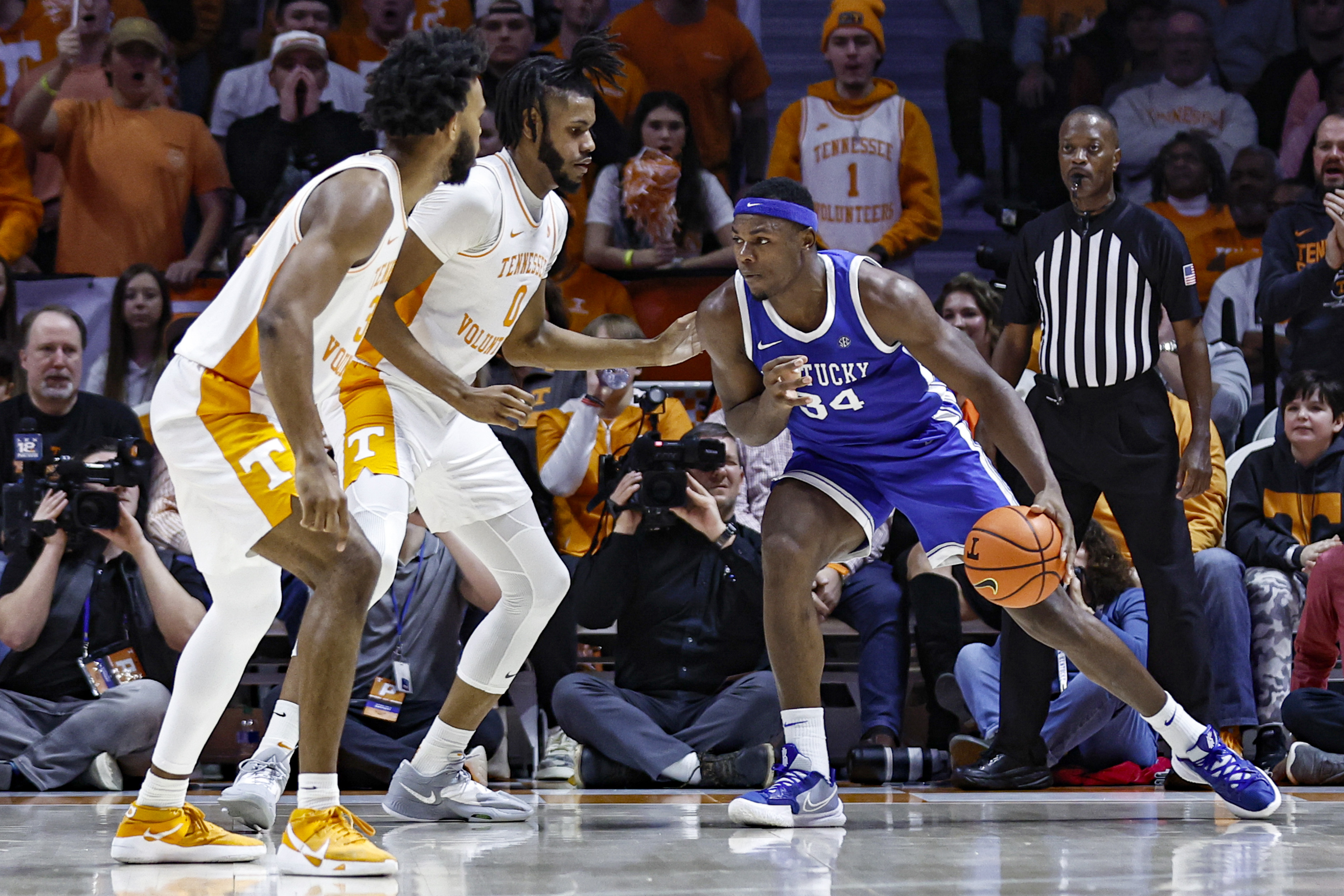 Kentucky forward Oscar Tshiebwe (34) looks for an opening as Tennessee forward Jonas Aidoo (0) and guard Josiah-Jordan James (30) defend during the first half of an NCAA college basketball game Saturday, Jan. 14, 2023, in Knoxville, Tenn. 