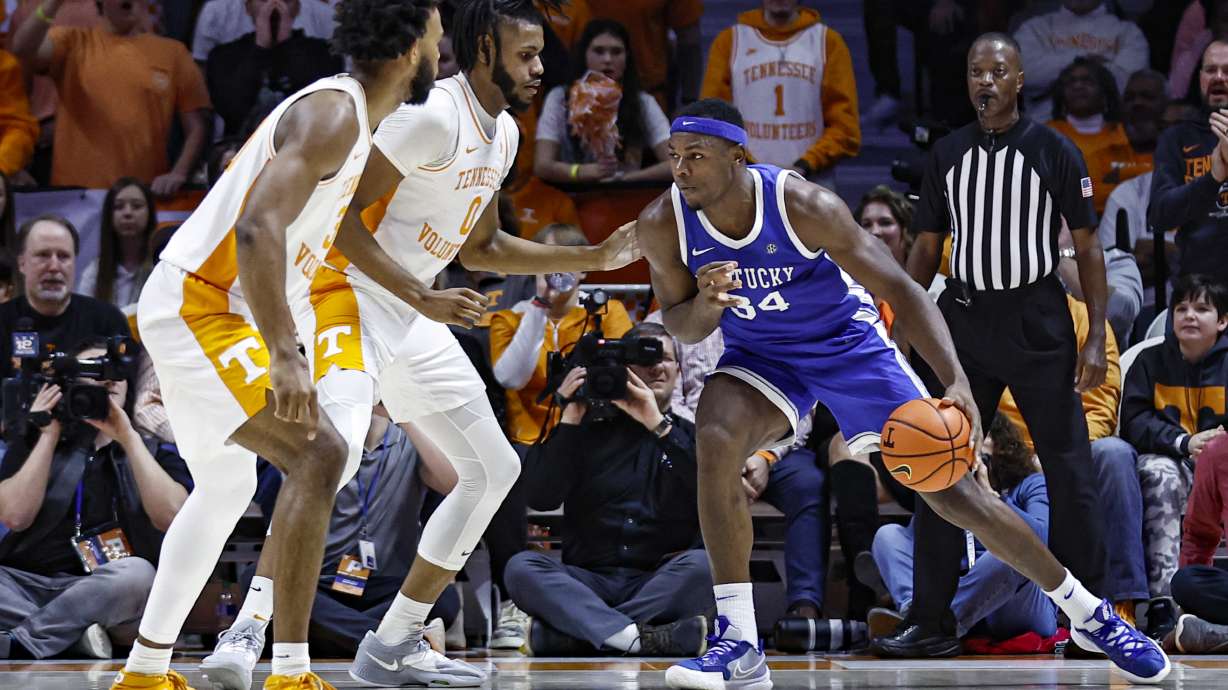 Kentucky forward Oscar Tshiebwe (34) looks for an opening as Tennessee forward Jonas Aidoo (0) and guard Josiah-Jordan James (30) defend during the first half of an NCAA college basketball game Saturday, Jan. 14, 2023, in Knoxville, Tenn.