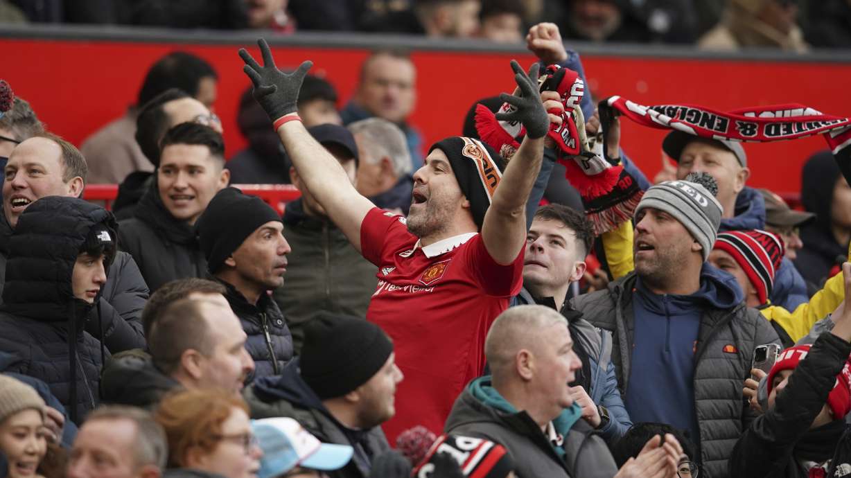 A fan cheers after Manchester United took the lead during the English Premier League soccer match between Manchester United and Manchester City at Old Trafford in Manchester, England, Saturday, Jan. 14, 2023.