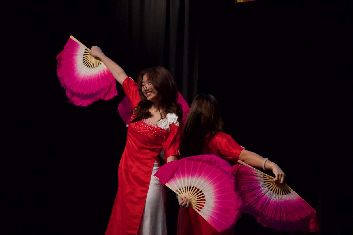 JJ Nguyen, front, and Haley Ngu of Doan Xuan Ca dance group perform a traditional Vietnamese fan dance at a Vietnamese New Year Celebration on Saturday at the Utah Cultural Celebration Center in West Valley.