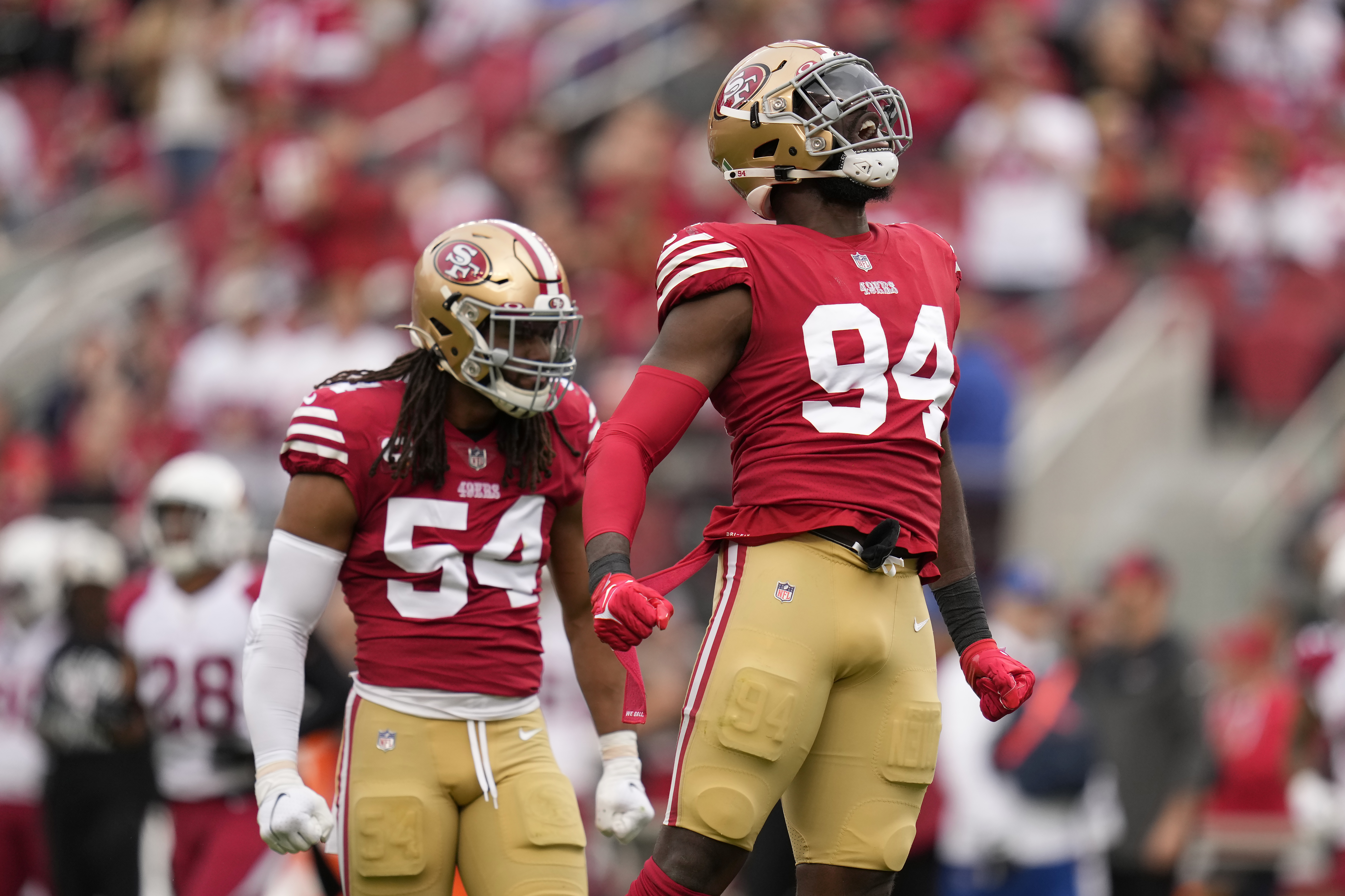 San Francisco 49ers defensive end Charles Omenihu (94) and linebacker Fred Warner (54) celebrate after defensive end Samson Ebukam sacked Arizona Cardinals quarterback David Blough during the first half of an NFL football game in Santa Clara, Calif., Sunday, Jan. 8, 2023.