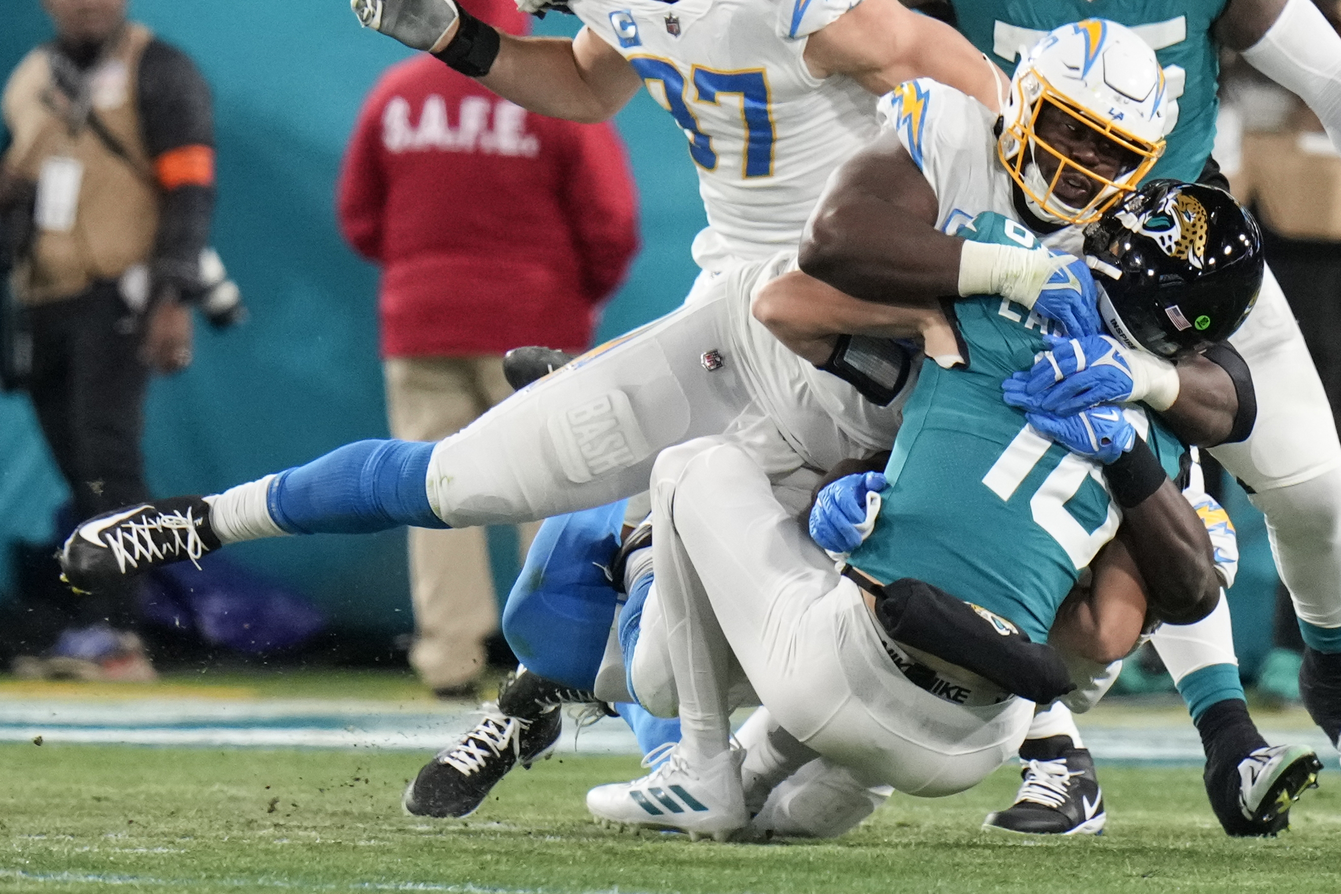Los Angeles Chargers defensive tackle Sebastian Joseph-Day (69) sacks Jacksonville Jaguars quarterback Trevor Lawrence (16) during the first of an NFL wild-card football game, Saturday, Jan. 14, 2023, in Jacksonville, Fla. 