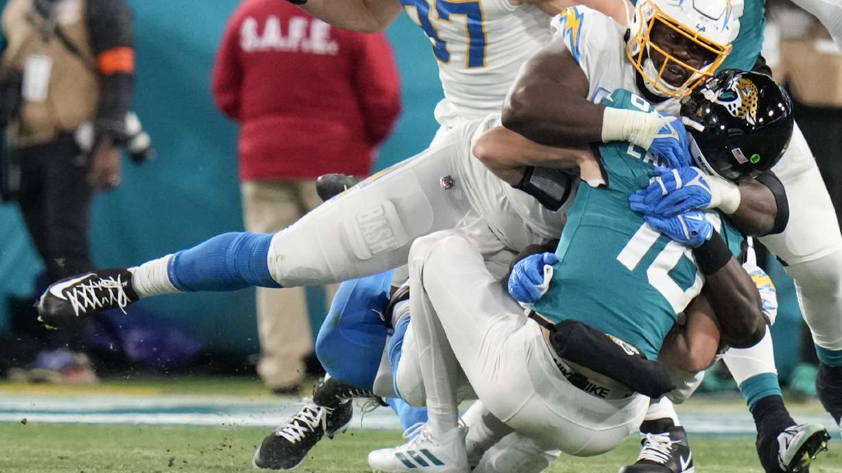Los Angeles Chargers defensive tackle Sebastian Joseph-Day (69) sacks Jacksonville Jaguars quarterback Trevor Lawrence (16) during the first of an NFL wild-card football game, Saturday, Jan. 14, 2023, in Jacksonville, Fla.