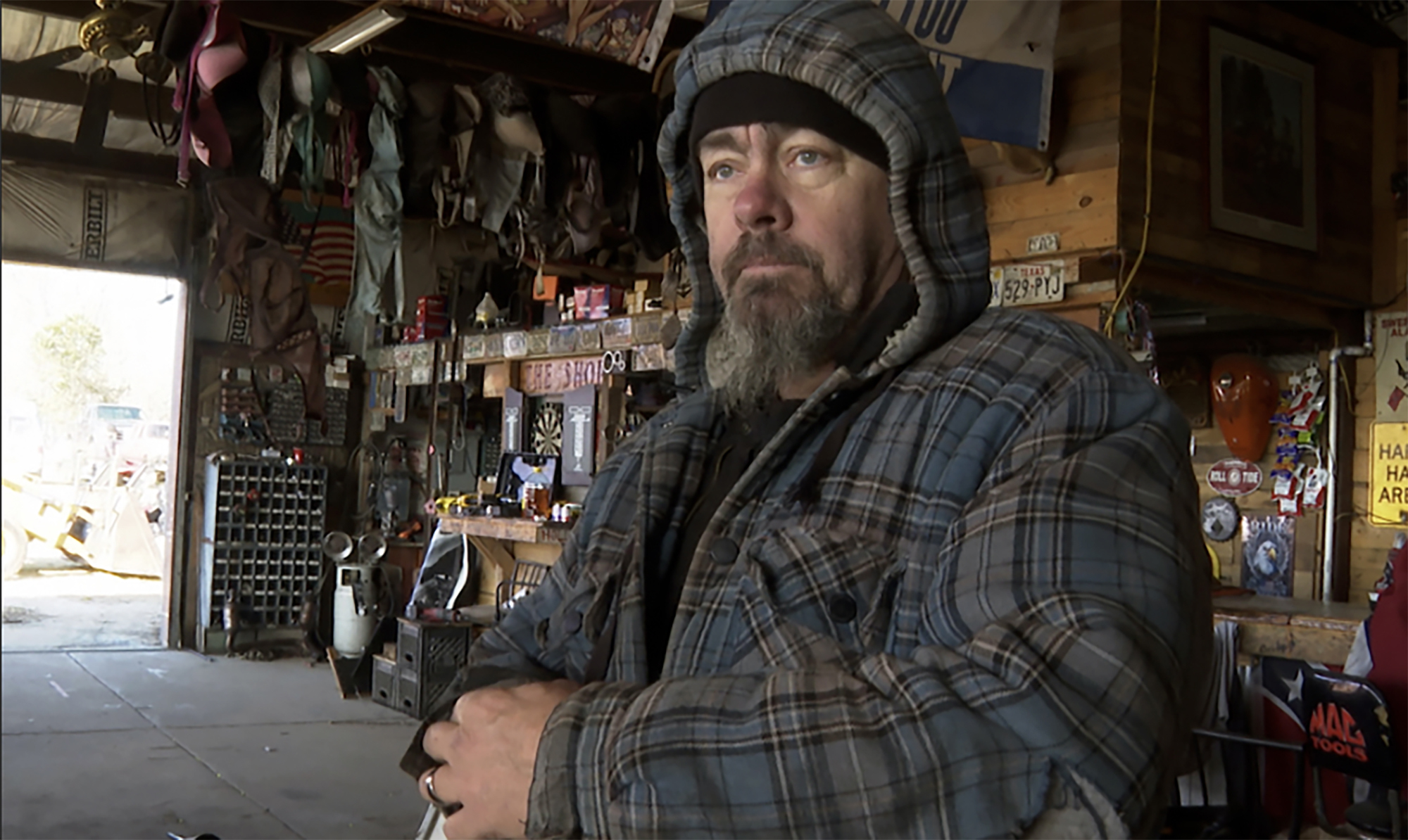 David Hollon stands inside his garage in Autauga County, Ala., on Saturday. The Alabama engine mechanic took refuge in a shipping container near the back of his garage as a tornado from Thursday's violent storm decimated his shop and killed two of his neighbors along its destructive path. 