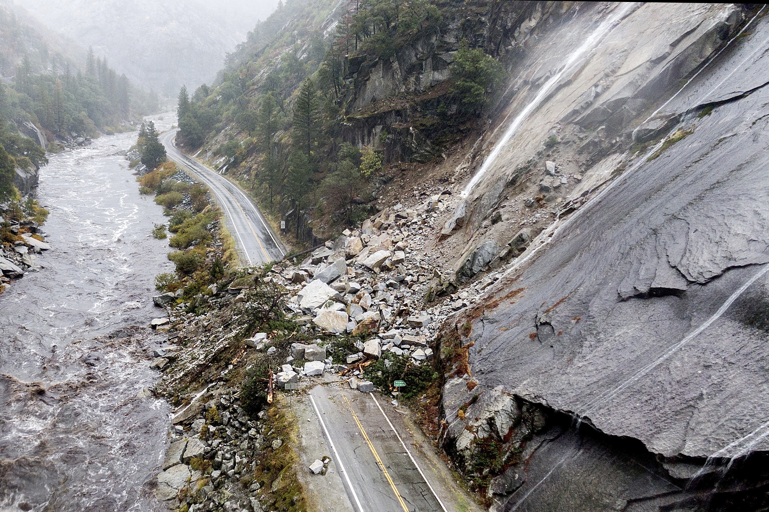 Rocks and vegetation cover Highway 70 following a landslide in the Dixie Fire zone on Oct. 24, 2021, in Plumas County, Calif.