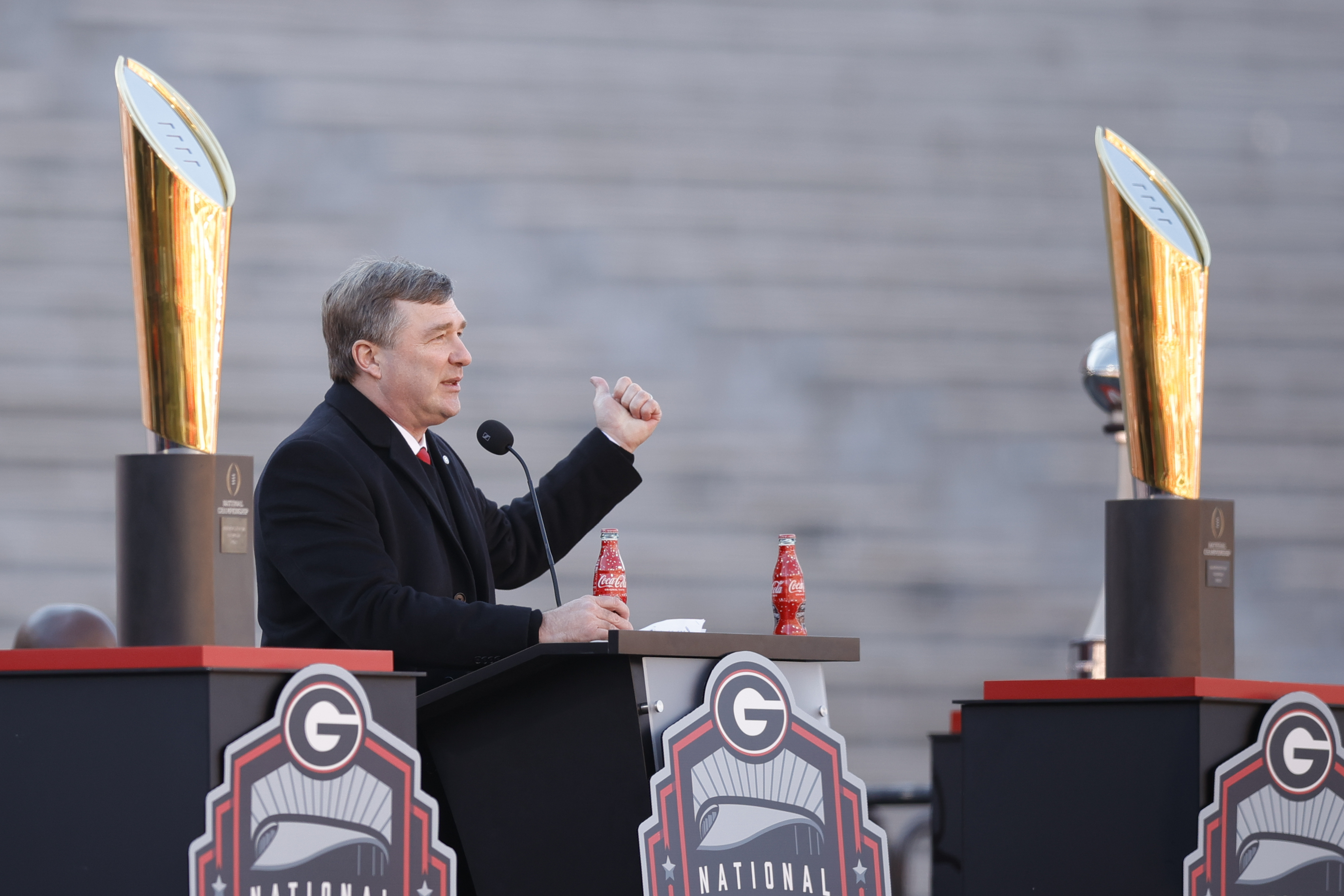 Georgia head coach Kirby Smart speaks while standing between the 2022 and 2023 championship trophies during a ceremony celebrating the Bulldog's second consecutive NCAA college football national championship, Saturday, Jan. 14, 2023, in Athens, Ga. 