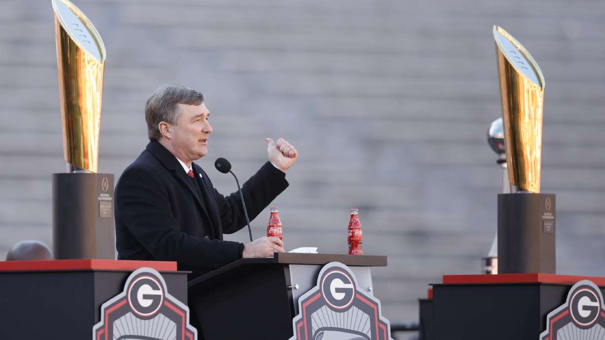 Georgia head coach Kirby Smart speaks while standing between the 2022 and 2023 championship trophies during a ceremony celebrating the Bulldog's second consecutive NCAA college football national championship, Saturday, Jan. 14, 2023, in Athens, Ga.