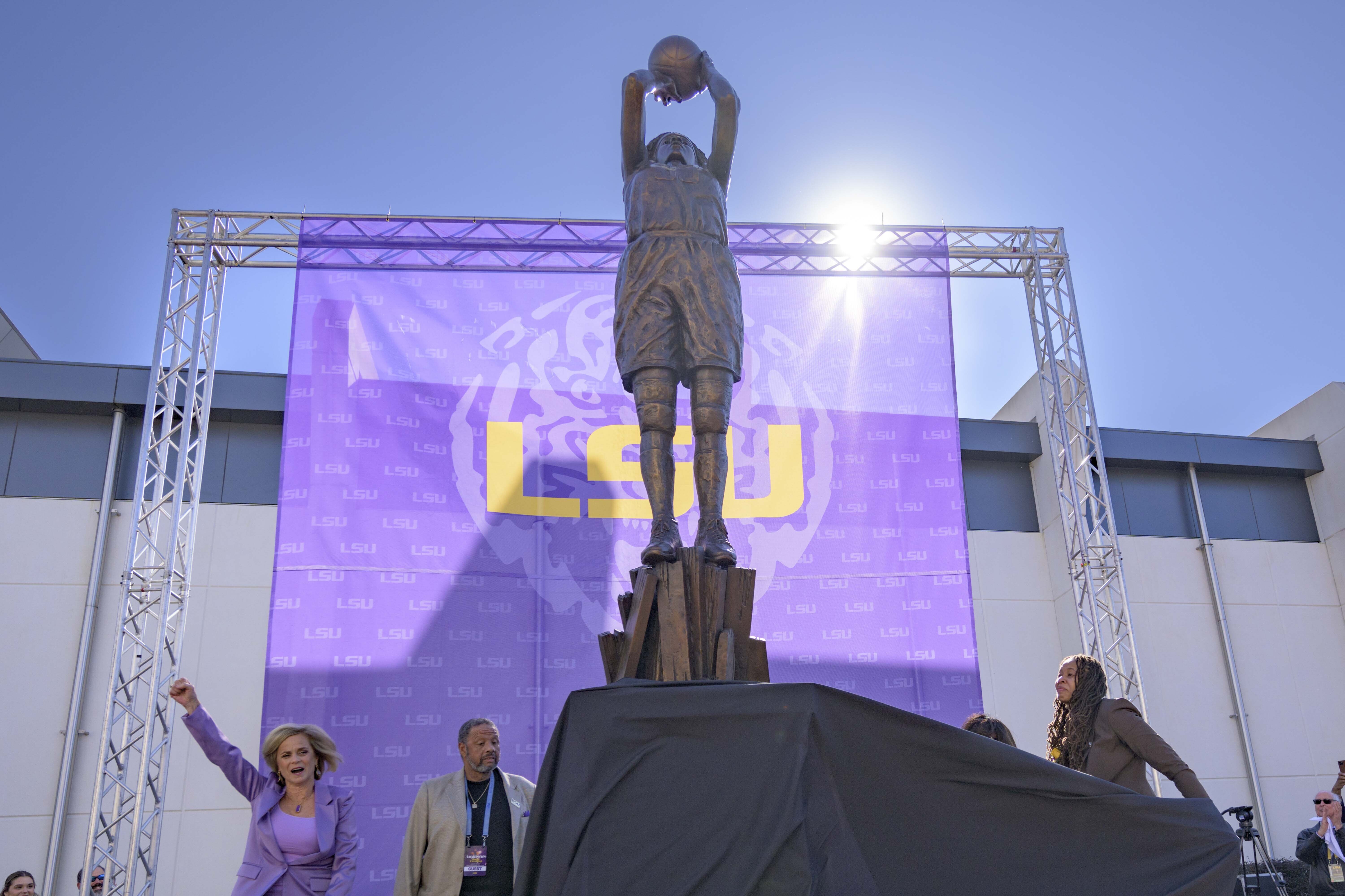 Seimone Augustus, right, a former LSU player who lead her team to multiple final fours and a Minnesota Lynx player who won four WNBA Championships, unveils her statue with LSU head coach Kim Mulkey, left, at the LSU campus on Sunday, Jan. 15, 2023, in Baton Rouge, La. 