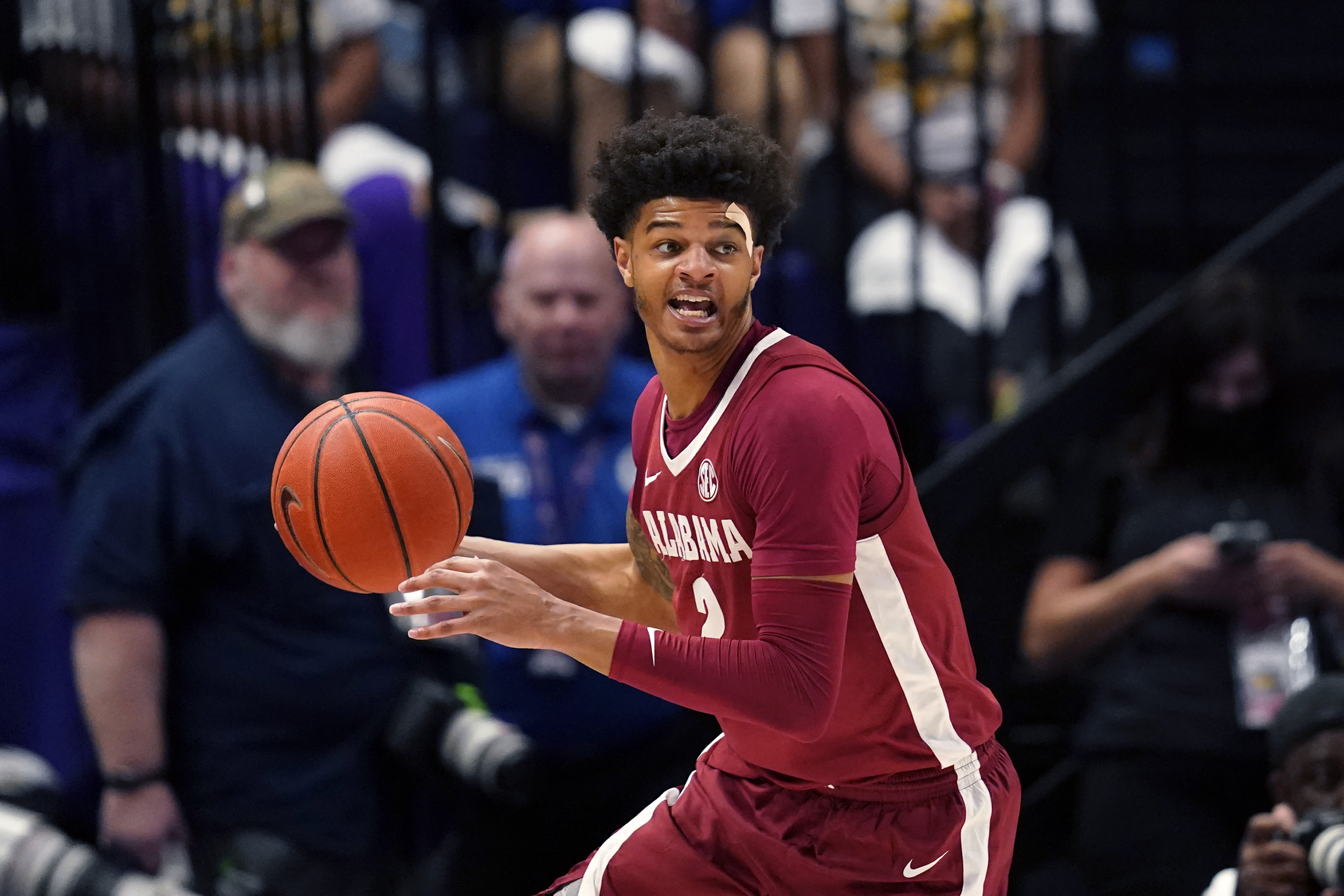 FILE - Alabama forward Darius Miles looks to pass in the second half an NCAA college basketball game against LSU in Baton Rouge, La., March 5, 2022. Miles is one of two suspects charged with capital murder in a predawn deadly shooting on the Strip in Tuscaloosa, Ala., Sunday, Jan. 15, 2023. 