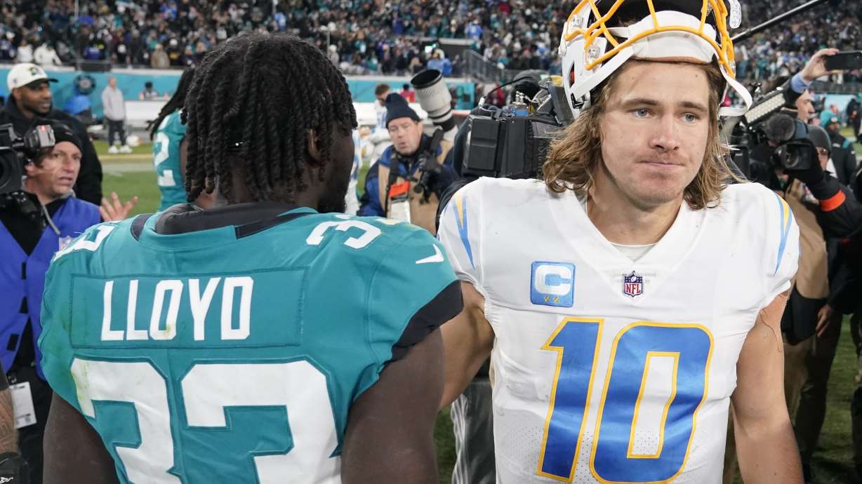 Los Angeles Chargers quarterback Justin Herbert (10) walks off the field after an NFL wild-card football game against the Jacksonville Jaguars, Saturday, Jan. 14, 2023, in Jacksonville, Fla. Jacksonville Jaguars won 31-30.