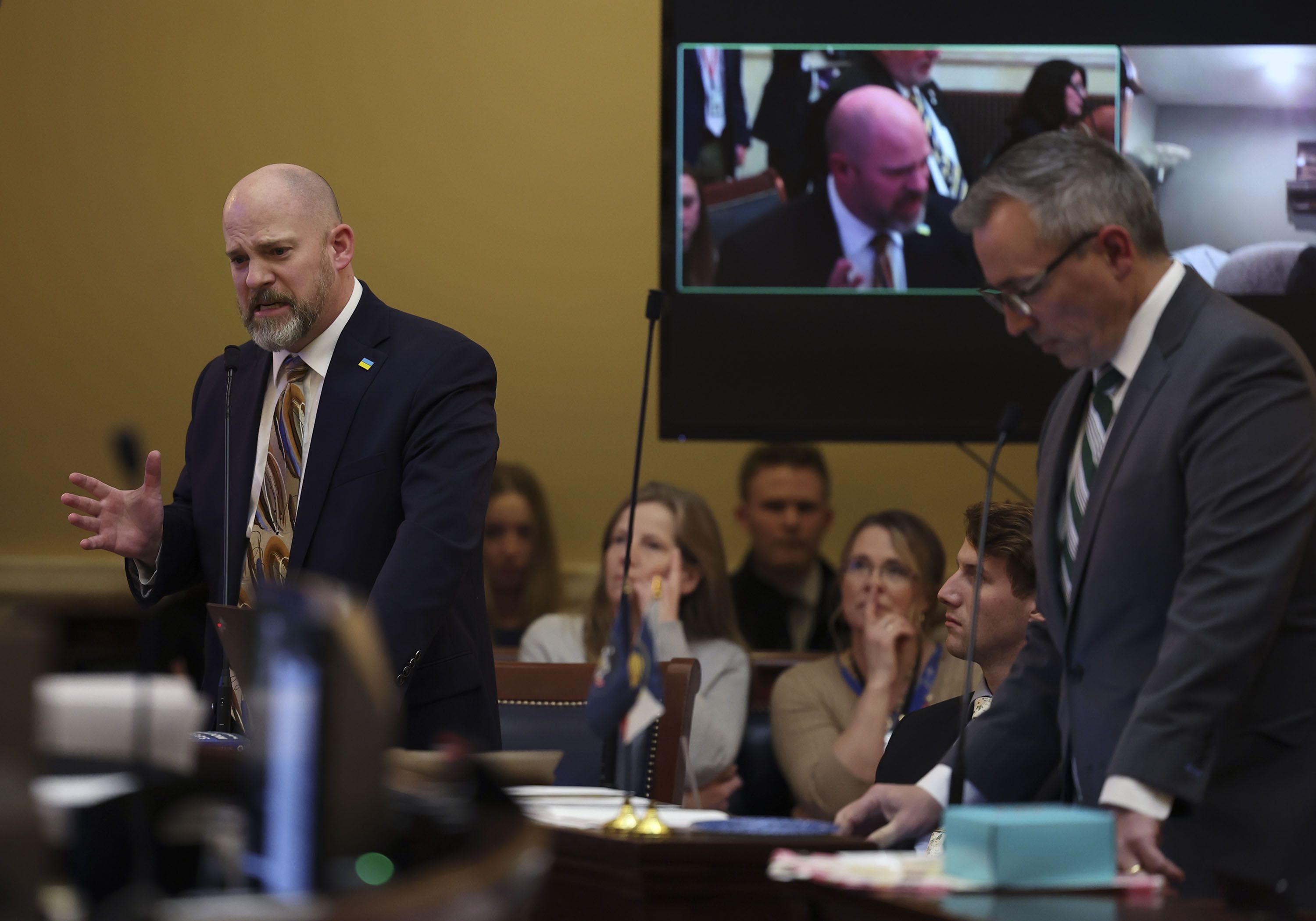 Sen. Daniel Thatcher, R-West Valley City, left, speaks against HB11 as Sen. Daniel McCay, R-Riverton, right, stands with his head bowed during the last evening of the Utah Legislature’s 2022 general session at the Capitol in Salt Lake City on March 4, 2022.