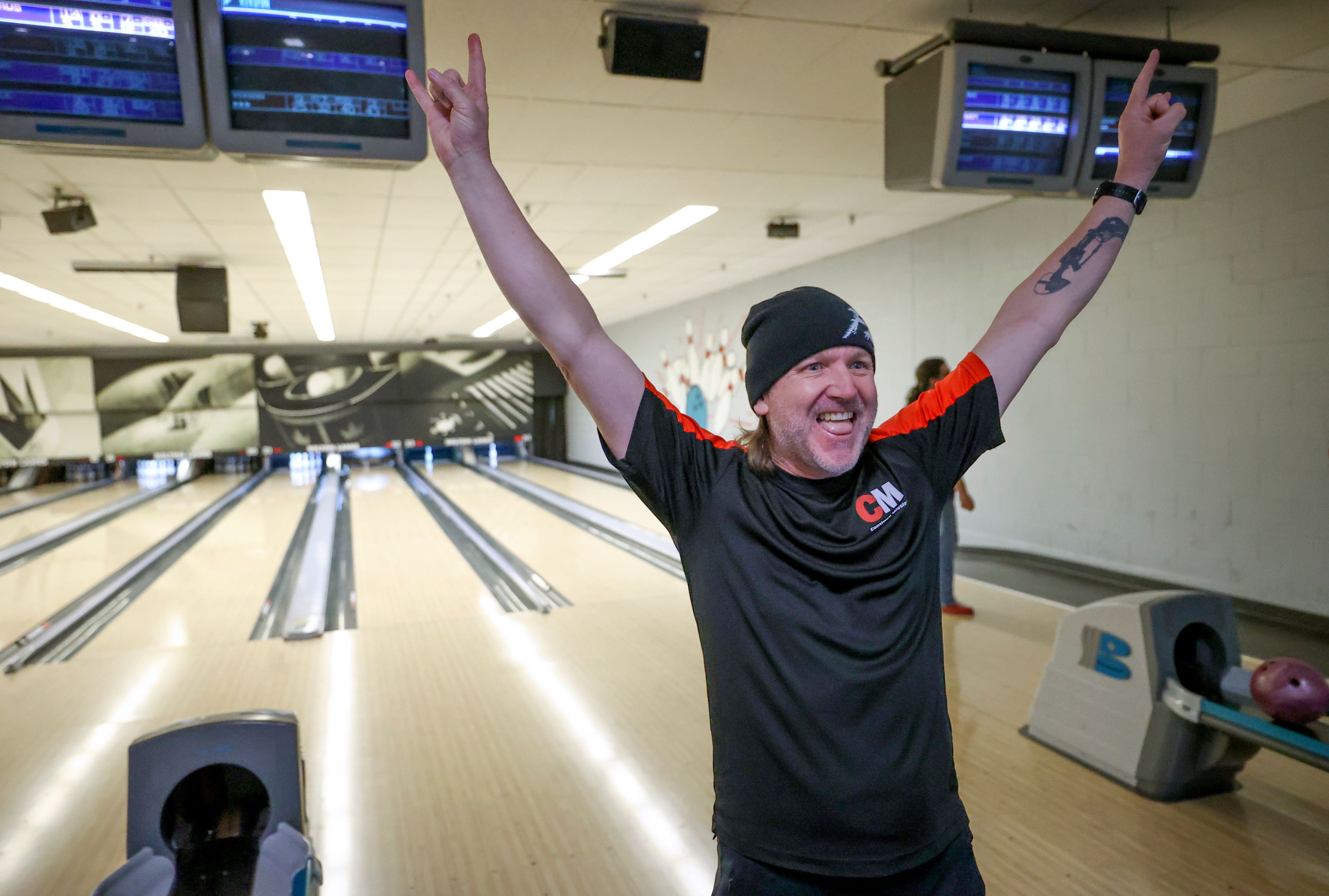 Josh Hansen, medically retired Army veteran and co-founder of Continue Mission, reacts to getting a strike while bowling with Continue Mission, an organization that helps veterans with suicide prevention and mental health, at Delton Lanes in West Valley City on Jan. 5.
