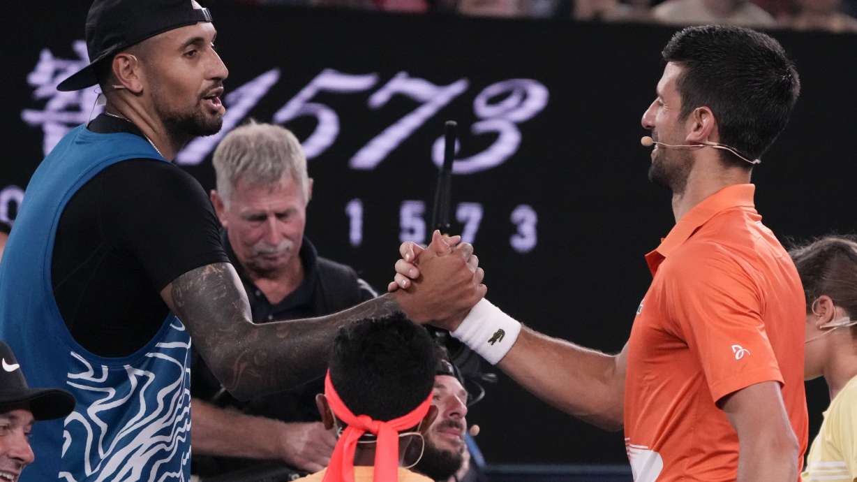 Australia's Nick Kyrgios, left, and Serbia's Novak Djokovic shake hands following an exhibition match on Rod Laver Arena ahead of the Australian Open tennis championship in Melbourne, Australia, Friday, Jan. 13, 2023.