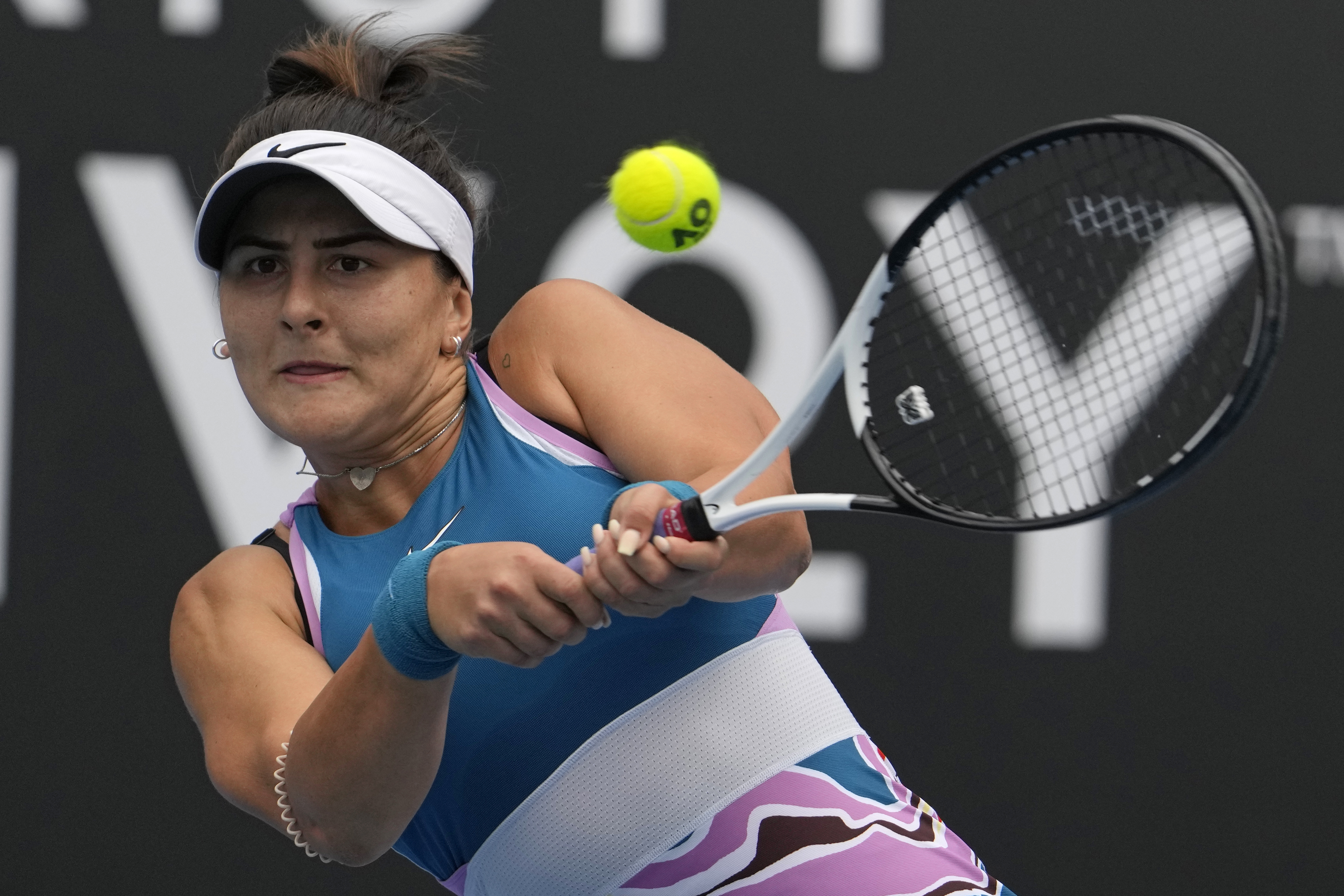 Bianca Andreescu of Canada plays a backhand return to Marie Bouzkova of the Czech Republic during their first round match at the Australian Open tennis championship in Melbourne, Australia, Monday, Jan. 16, 2023. 