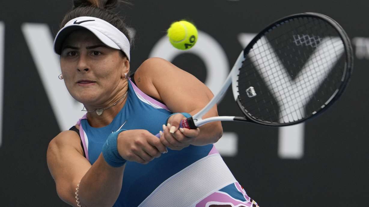Bianca Andreescu of Canada plays a backhand return to Marie Bouzkova of the Czech Republic during their first round match at the Australian Open tennis championship in Melbourne, Australia, Monday, Jan. 16, 2023.