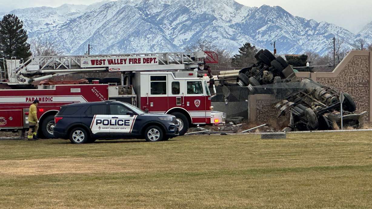 Emergency crews respond to a fatal rollover crash at the intersection of 3500 South and Mountain View Corridor in West Valley City Monday morning.