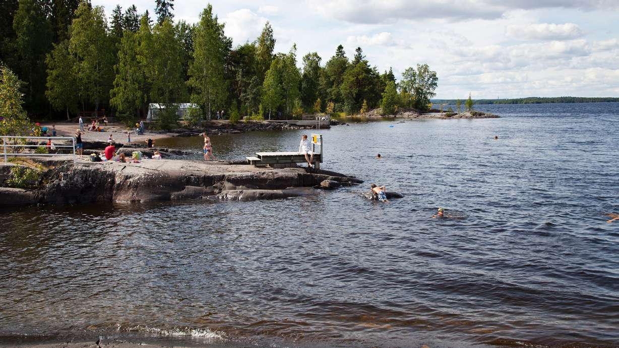 People enjoy nature at a lake in Finland. It may reduce the need for some medication, a study says.