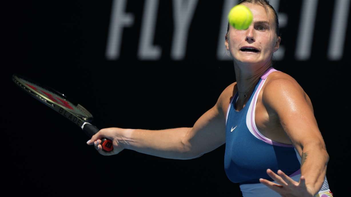Aryna Sabalenka of Belarus plays a forehand return to Tereza Martincova of the Czech Republic during their first round match at the Australian Open tennis championship in Melbourne, Australia, Tuesday, Jan. 17, 2023.