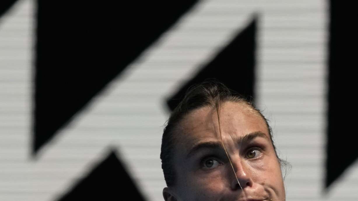 Aryna Sabalenka of Belarus plays a backhand return to Tereza Martincova of the Czech Republic during their first round match at the Australian Open tennis championship in Melbourne, Australia, Tuesday, Jan. 17, 2023.