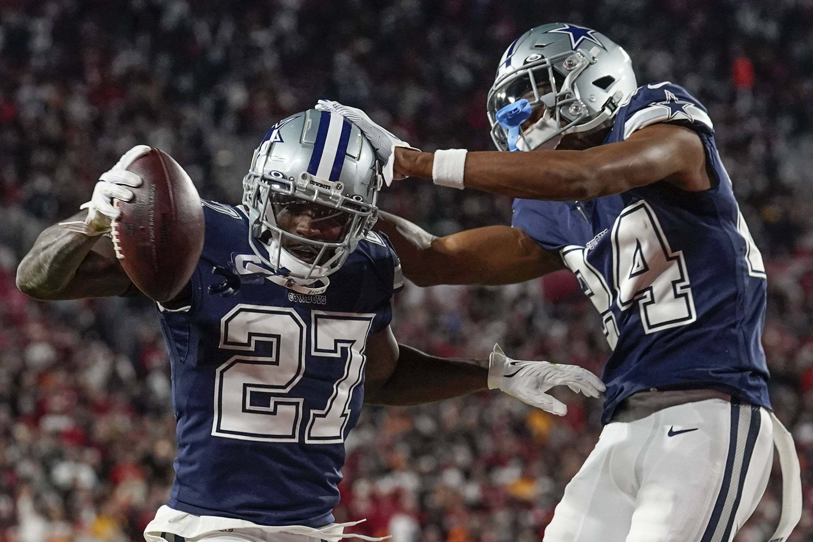 Dallas Cowboys safety Jayron Kearse (27) celebrates with safety Israel Mukuamu after intercepting the ball against Tampa Bay Buccaneers quarterback Tom Brady during the first half of an NFL wild-card football game, Monday, Jan. 16, 2023, in Tampa, Fla. 