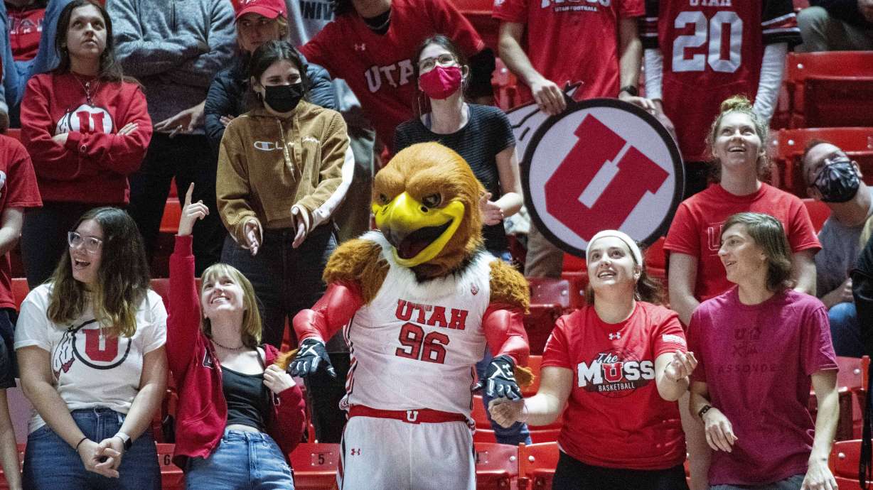 Swoop dances with fans in Utah's student section during the second half of an NCAA college basketball game against California on Sunday, Dec. 5, 2021, in Salt Lake City.