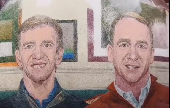 Artist uses sand to depict portraits of former NFL quarterbacks Peyton and Eli Manning.