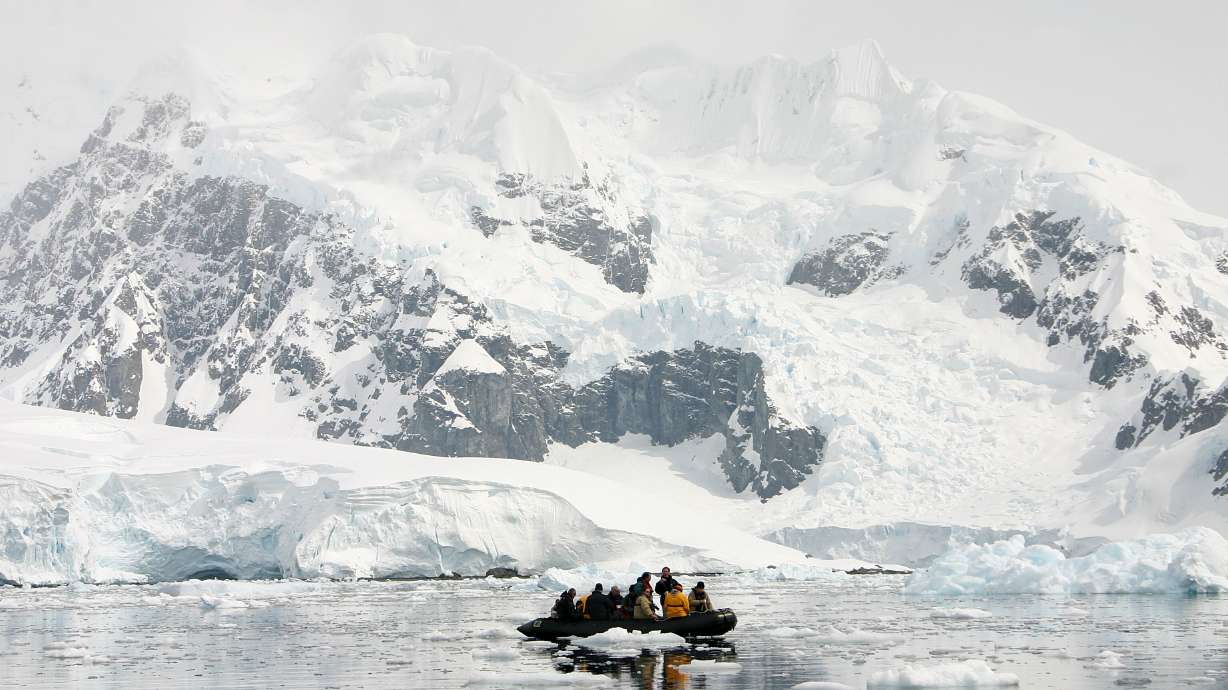 Tourists get close to icebergs and the Antarctic coast during a short excursion on a Zodiac boat in Brown Bluff, Antarctica, December 2005. A new BYU study compares explorer observations from the 1700s with modern satellite datasets.