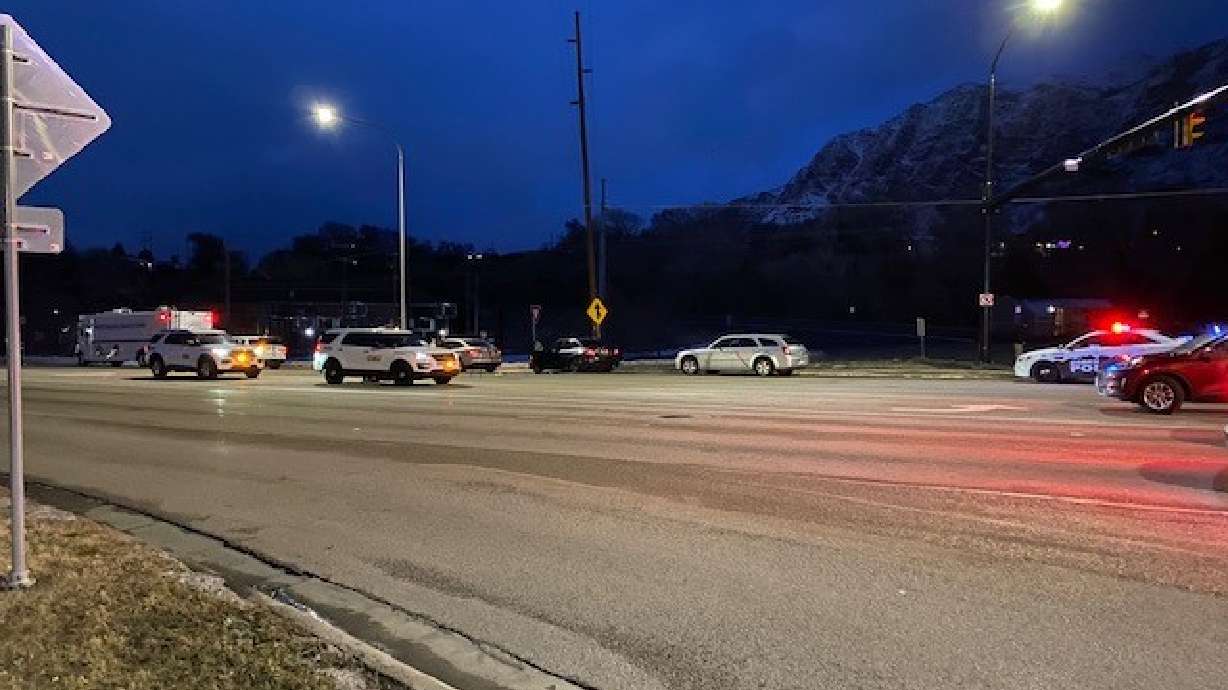 Police investigate a fatal shooting near Harrison Boulevard and 12th Street in Ogden Tuesday evening. Two men were charged Friday in connection with the homicide.