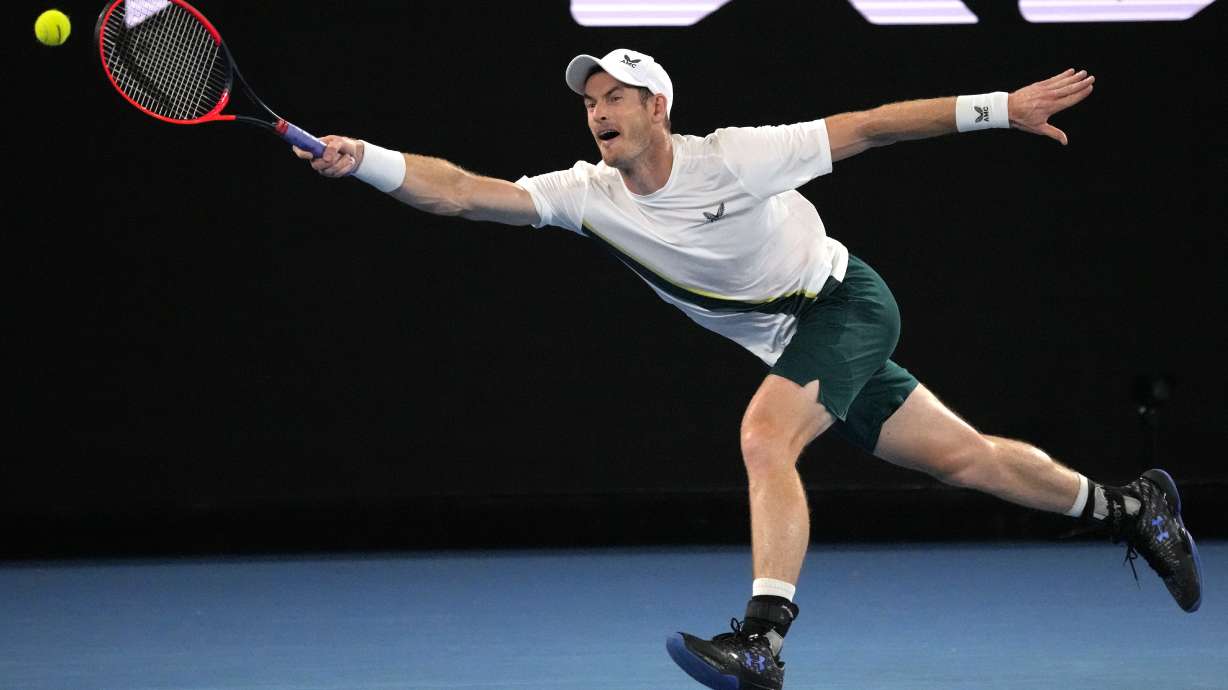 Andy Murray of Britain plays a forehand return to Matteo Berrettini of Italy during their first round match at the Australian Open tennis championship in Melbourne, Australia, Tuesday, Jan. 17, 2023.