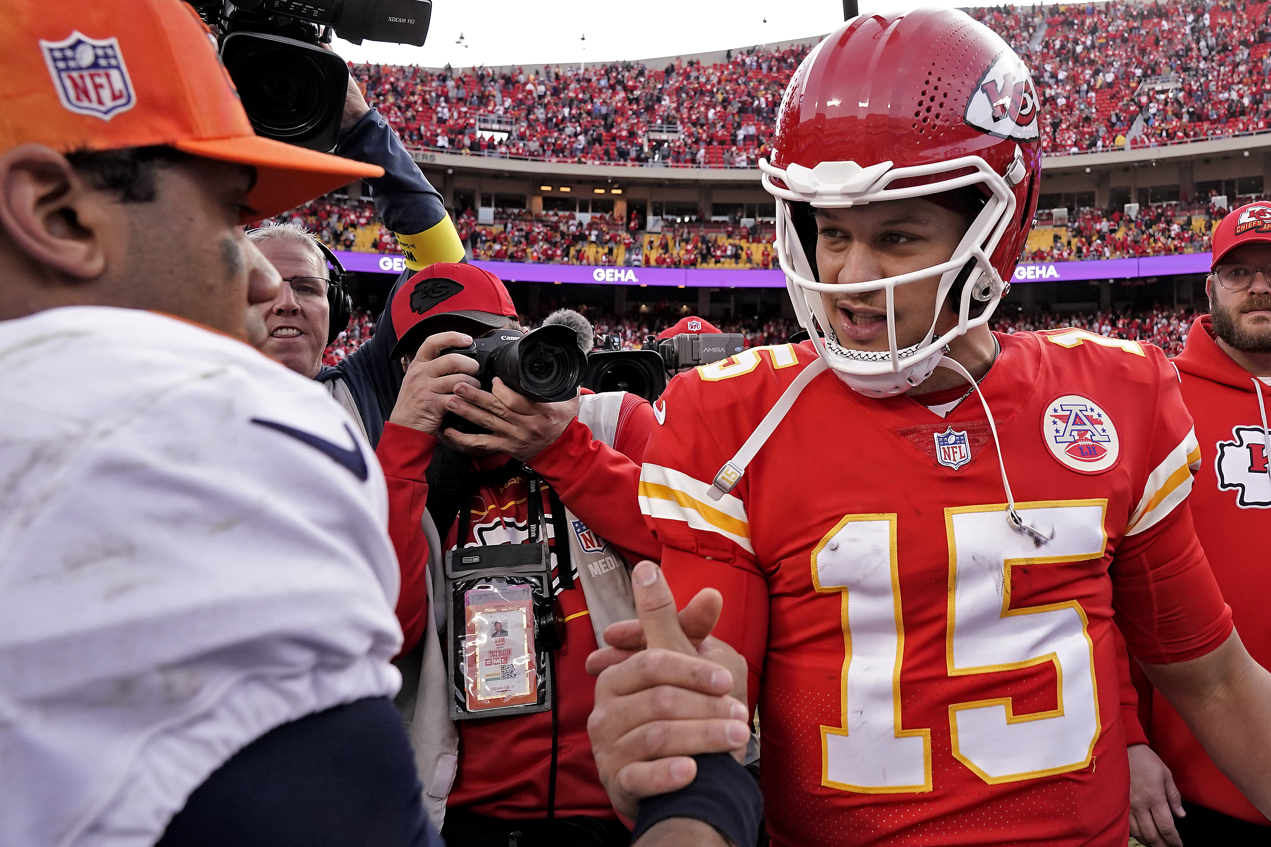 Kansas City Chiefs quarterback Patrick Mahomes (15) and Denver Broncos quarterback Russell Wilson (3) greet each other after an NFL football game Sunday, Jan. 1, 2023, in Kansas City, Mo. 