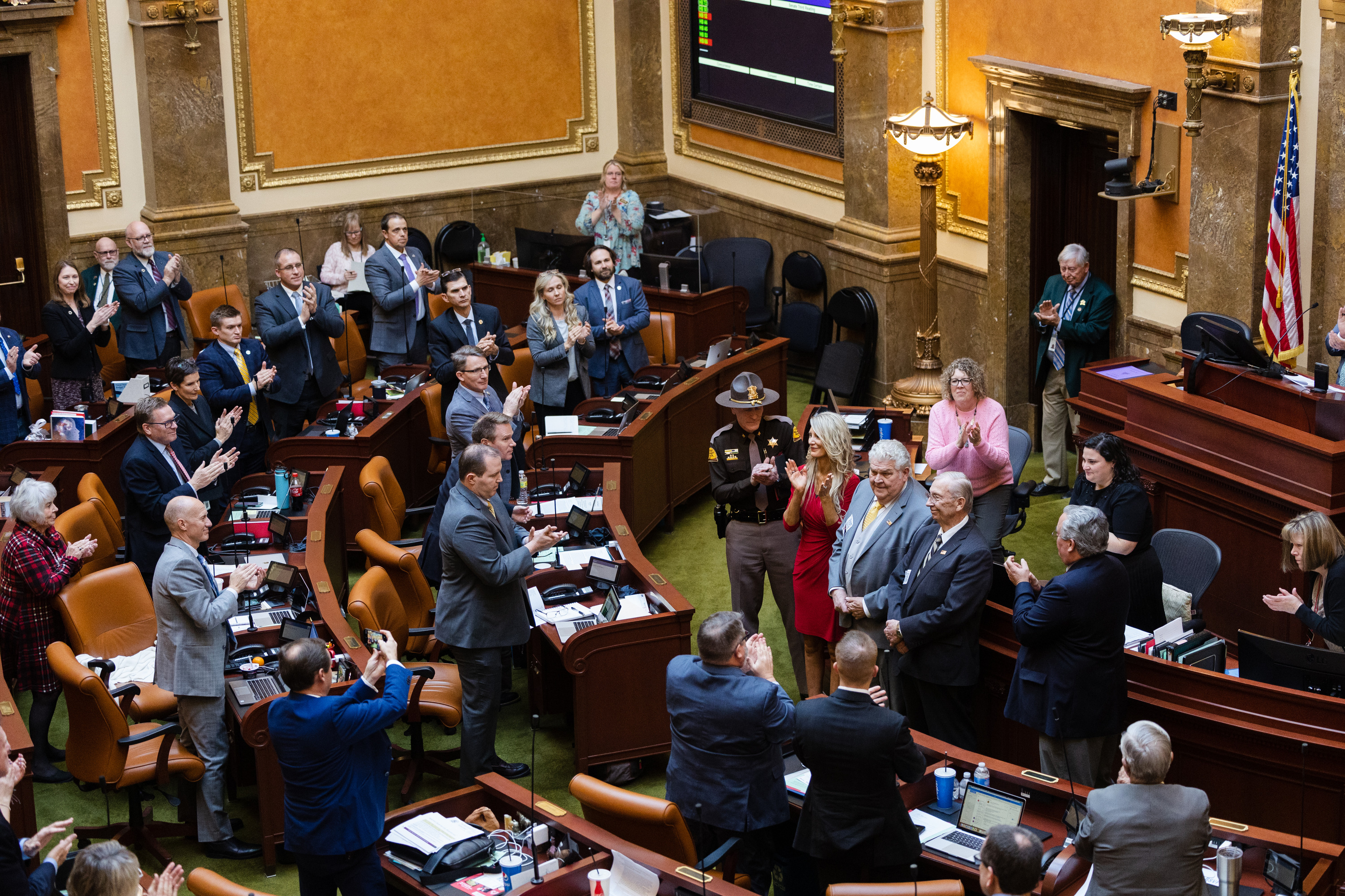 Dr. Stanley Green and retired Utah Highway Patrol trooper Ralph Evans are given a standing ovation in the House of Representatives at the state Capitol in Salt Lake City on Wednesday.