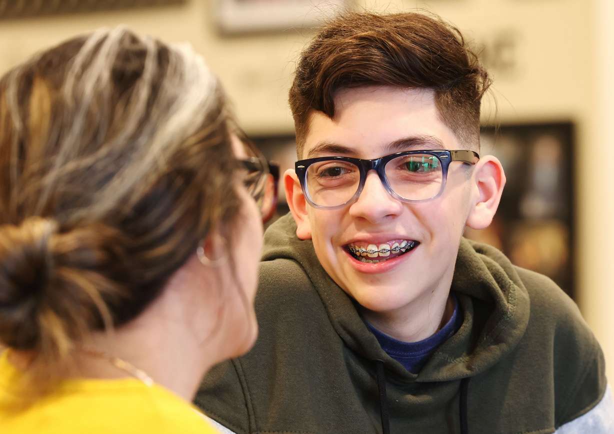 Veronica Bernard and her 15-year-old son Jacob talk as they pose for photos in their West Jordan home on Monday.