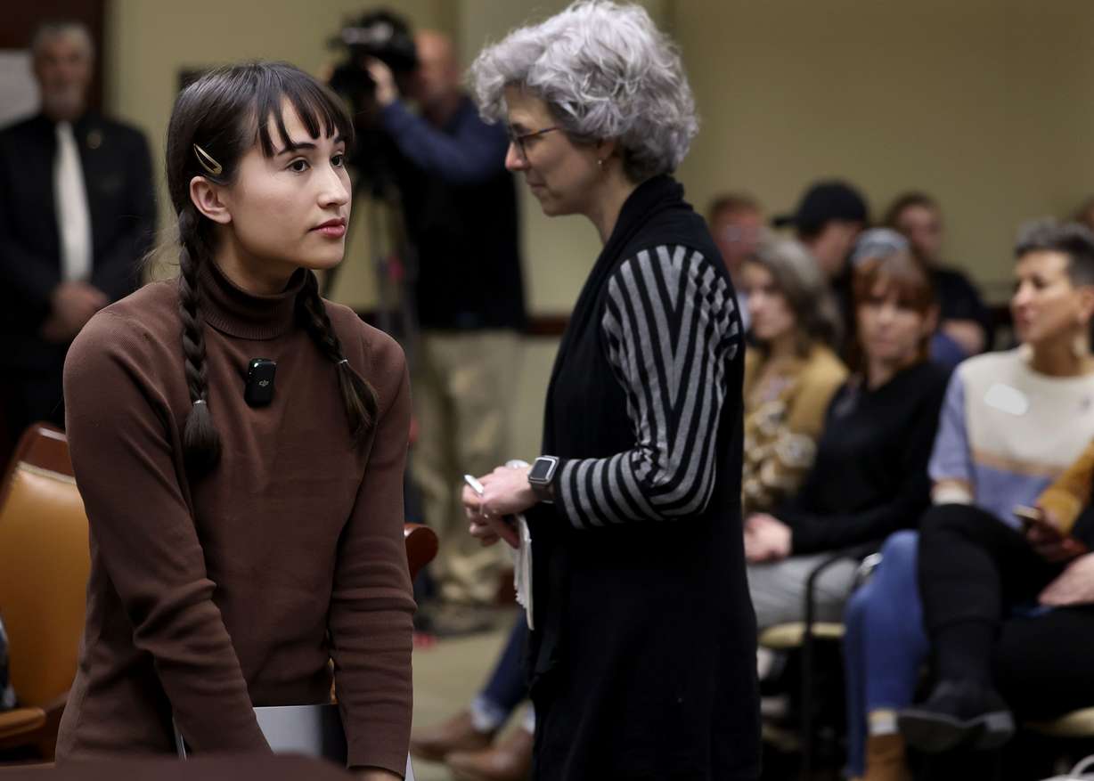 Chloe Cole, a self-described former transgender child who de-transitioned, left, returns to her seat after speaking about SB16 “Transgender Medical Treatments and Procedures Amendments,” as Dr. Nicole Mihalopoulos walks to the table to speak during a Senate Health and Human Services Standing Committee meeting at the Capitol in Salt Lake City on Wednesday.