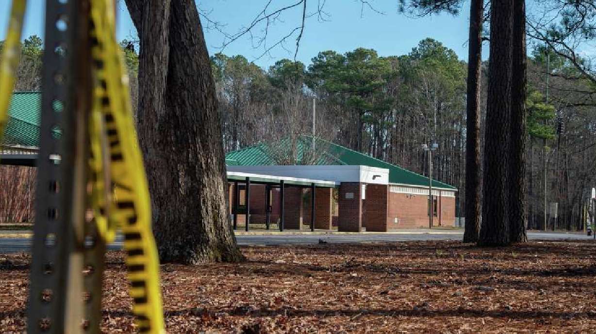 Police tape hangs from a sign post outside Richneck Elementary School following a shooting on January 7 in Newport News, Virginia. A 6-year-old student was taken into custody after reportedly shooting a teacher during an altercation in a classroom at Richneck Elementary School.
