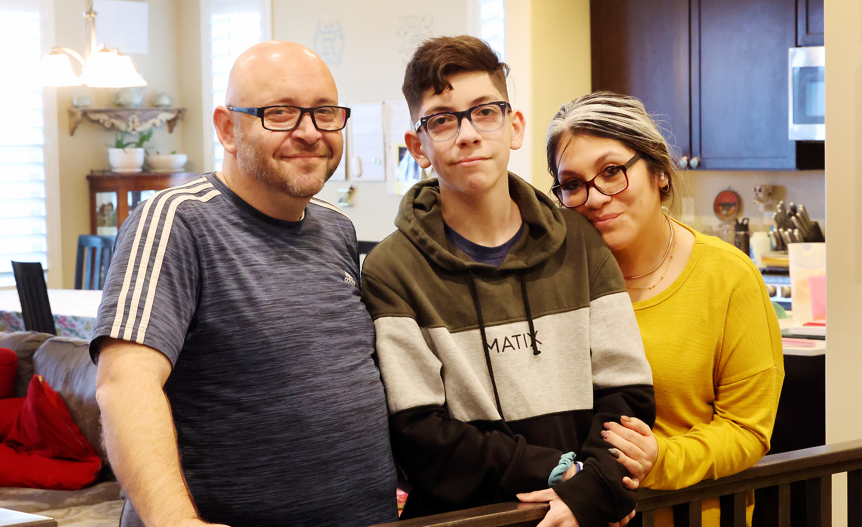 Michael and Veronica Bernard and their 15-year-old son Jacob pose for photos in their West Jordan home on Monday. Many parents of autistic children endure a frustrating process to receive help for their children, according to Utah Parent Center executive director Joey Hanna.