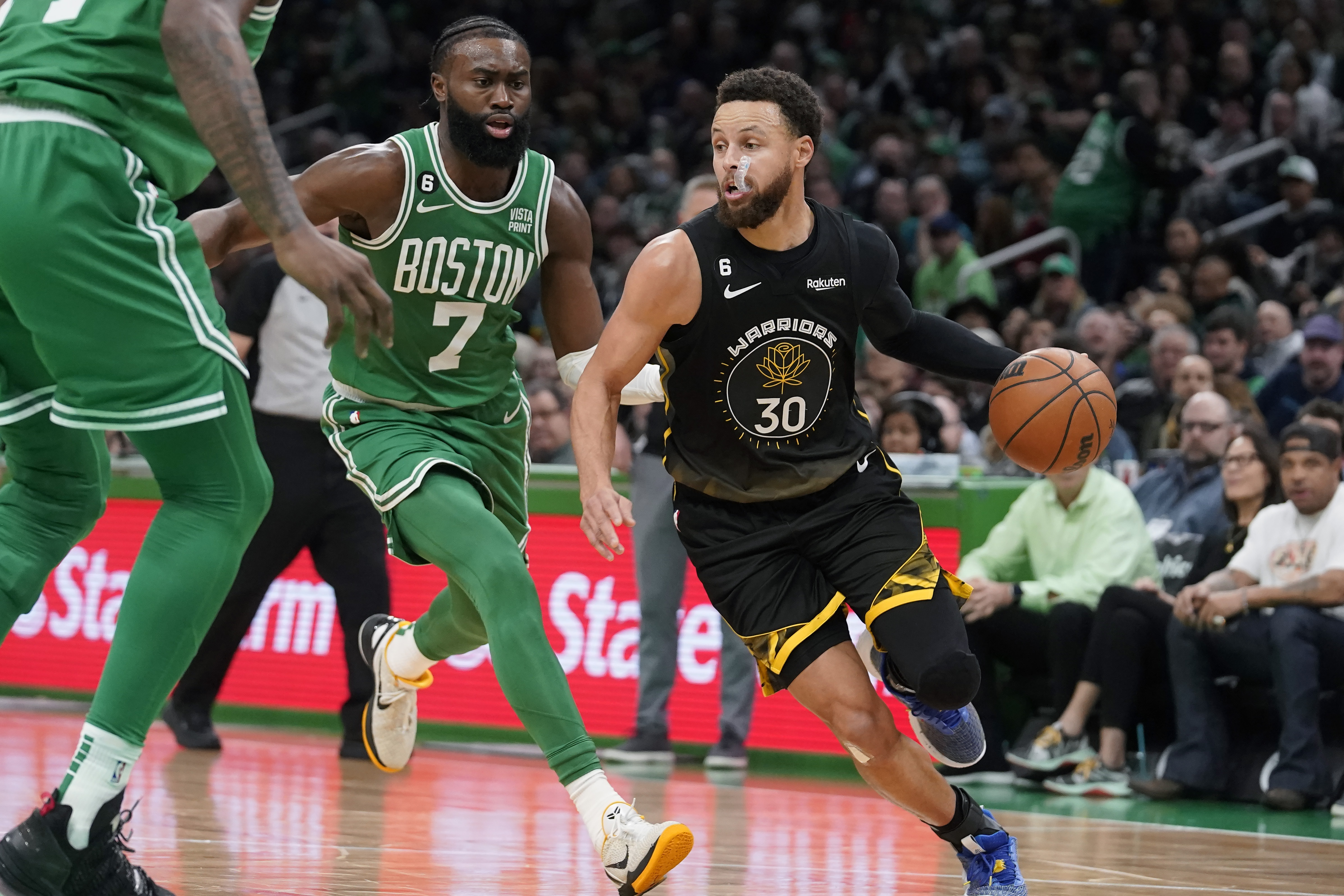 Golden State Warriors guard Stephen Curry (30) drives toward the basket past Boston Celtics guard Jaylen Brown (7) in the first half of an NBA basketball game, Thursday, Jan. 19, 2023, in Boston. 