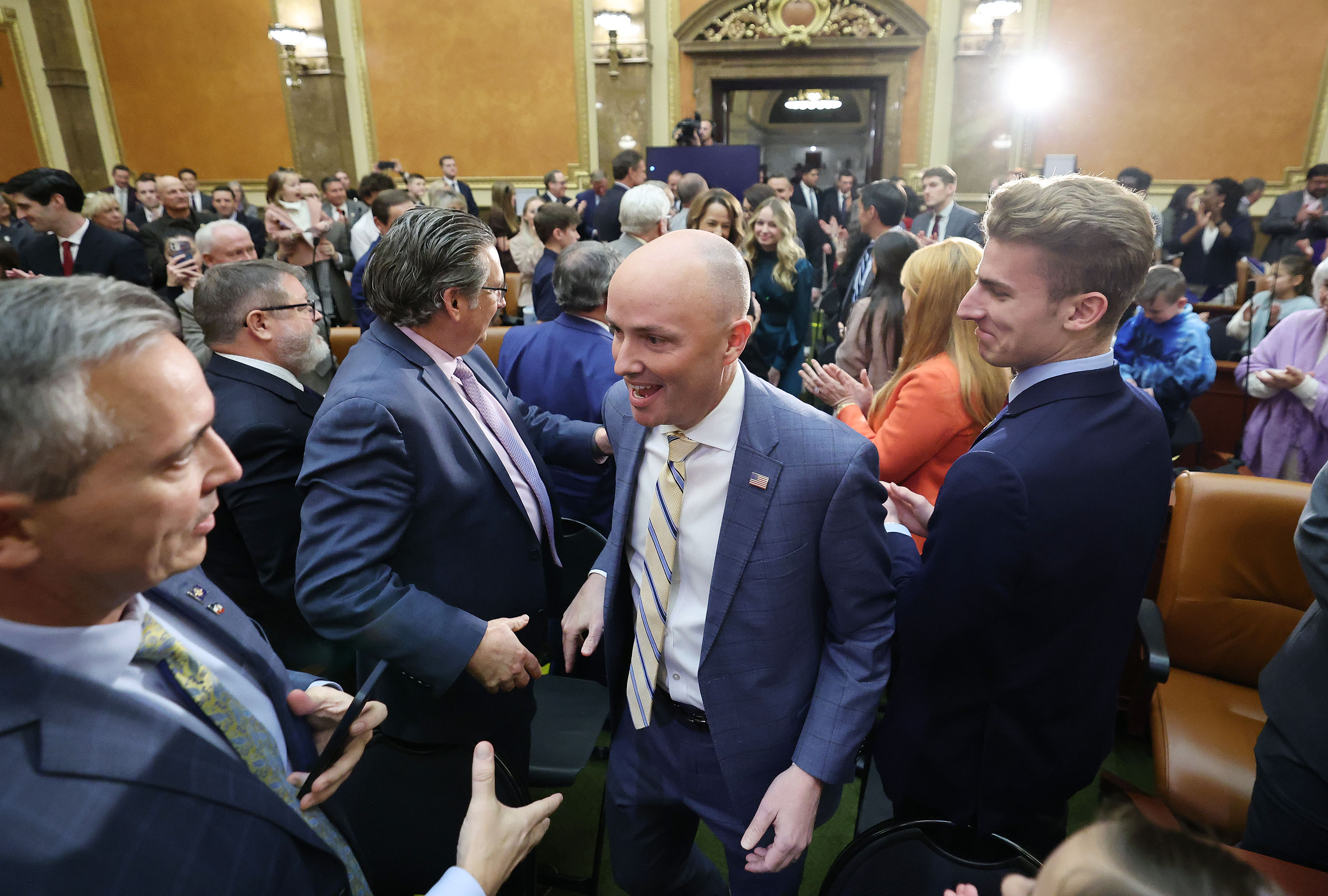Gov. Spencer Cox greets Sen. Daniel McCay, R-Riverton, and Sen. Chris Wilson, R-Logan, as he enters the House of Representatives for his 2023 State of the State address to the legislature at the Capitol in Salt Lake City on Thursday.